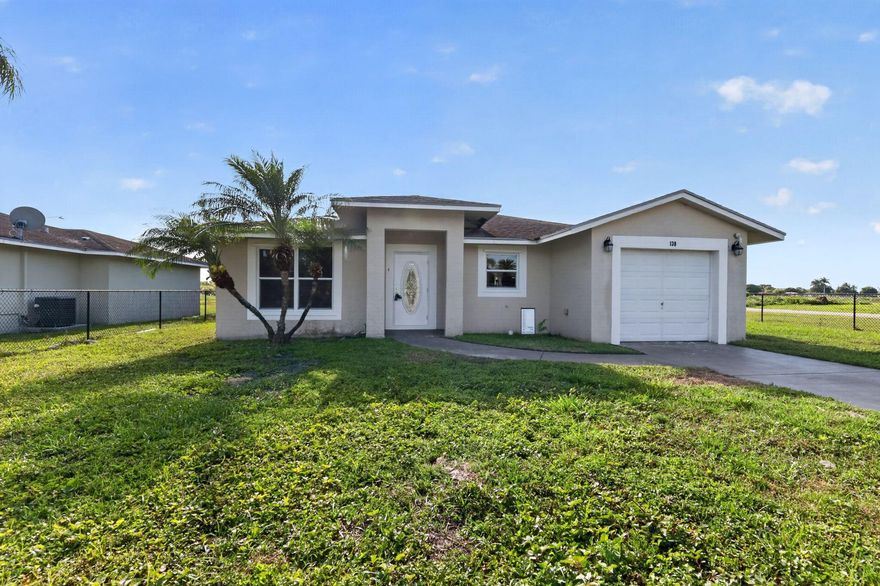 This well-maintained 4-bedroom, 2-bathroom home offers 1,466 square feet of comfortable living on a generous 8,107 square foot lot, and it's truly turnkey. Fresh interior paint and new bedroom carpets mean there's nothing to do but move in. The kitchen is outfitted with stainless steel appliances and granite countertops, providing a clean and functional space for everyday living. The layout is practical and family-friendly, with good-sized bedrooms and a comfortable flow throughout. Situated in Belle Glade, a quiet farming community known for its affordability and relaxed pace of life, the home is conveniently located near John Stretch Park, Pahokee State Park, and Slim's Fish Camp; great options for outdoor recreation.