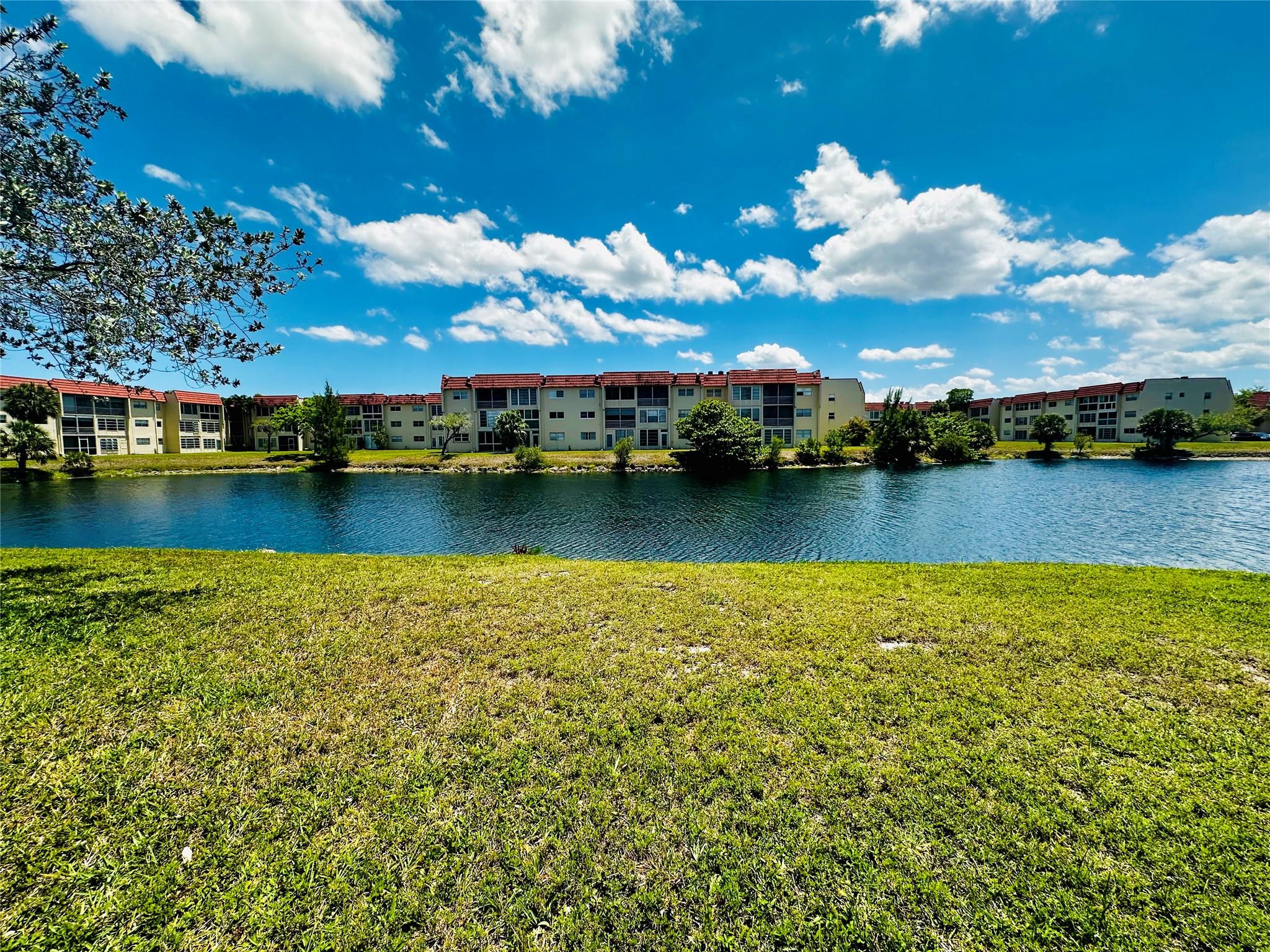 Discover the perfect blend of convenience and tranquility in this beautifully maintained 1-bedroom, 1-bath ground-floor corner unit. Freshly painted with spotless carpets, this charming condo offers a serene water view, creating a peaceful retreat you'll love coming home to. Ideally located just steps away from the mailbox and laundry room, the unit combines practicality with ease of living. Whether you want to downsize, simplify, or invest, this is a rare opportunity to own a move-in-ready gem in a highly sought-after community.