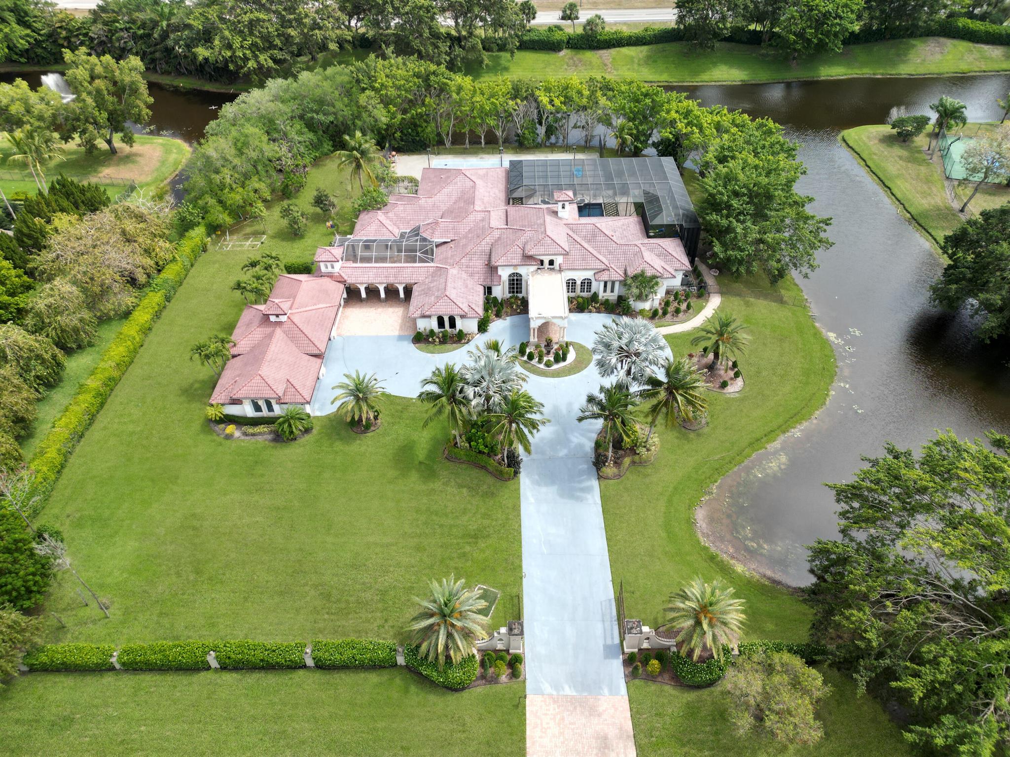 FURNISHED RENT. Nestled within an ultra-exclusive gated enclave of just 52 homes in Tierra Del Rey Estates South, this extraordinary estate offers a rare blend of elegance, privacy, and resort-style living. Spanning 3.4 ACRES and surrounded by a tranquil LAKE on three sides, this breathtaking property is truly unique. Step inside to discover FIVE spacious bedrooms, complemented by a dedicated GYM, private OFFICE, children's playroom, and a state-of-the-art MOVIE THEATER--all designed to enhance both comfort and entertainment. The open-concept living spaces are bathed in natural light, offering seamless indoor-outdoor integration. The outdoor experience is nothing short of spectacular. A soaring 21-foot enclosed pool lanai features a summer kitchen, creating the ultimate space for