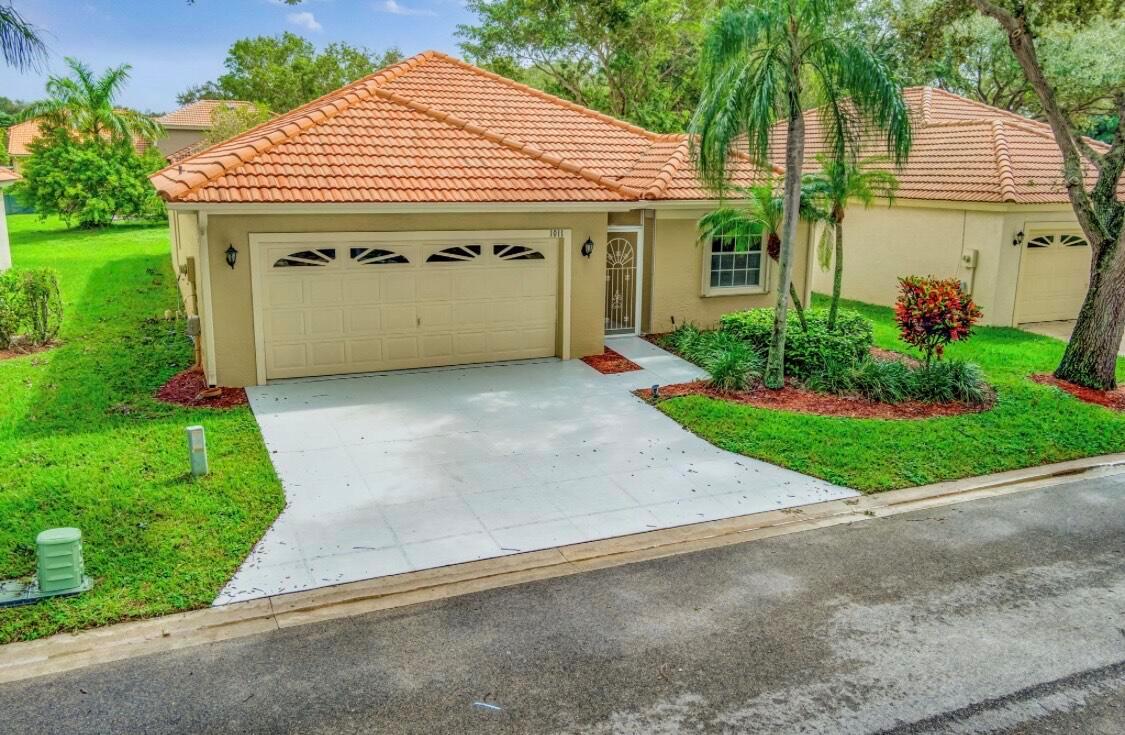 NEW ROOF AND AC installed in July 2025. Screened-in patio with a water view. This immaculate home is well-maintained. Tile in the bathrooms and kitchen. Carpet in the living room and bedrooms. Located in a gated community that borders Palm Beach Gardens. Ten minutes to the beach or the famous Blue Heron Bridge for excellent snorkeling and swimming. Shopping is minutes away. Vaulted ceilings and accordion shutters. The community has a clubhouse with an exercise room, 2 racquetball courts, volleyball, 3 pools, and one is heated in the wintertime. soccer field, tot lot, and more. HOA is $292 monthly, Partial Lawn Service, Basic Cable, and Irrigation. Security & more. Up to 2 Pets are Okay. Motorcycles must be garaged at night. Boat and RV storage available.