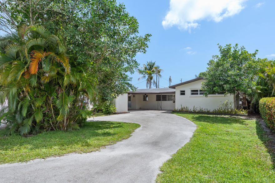 This 3-bedroom, 2-bath home offers the charm of classic design with endless potential to make it your own. Situated on a large lot, the property features a circular driveway, covered carport, and ample outdoor space. Inside, you'll find an open-concept layout with a spacious living area and a den; perfect for a home office, playroom, or additional lounge space. The kitchen provides a generous footprint, offering the ideal opportunity to design and create your dream kitchen. All three bedrooms are well-sized, complemented by two full bathrooms. The backyard offers additional storage and plenty of room for customization, expansion, or outdoor entertaining. A great opportunity for buyers looking to add value while enjoying the character of a home with traditional appeal.