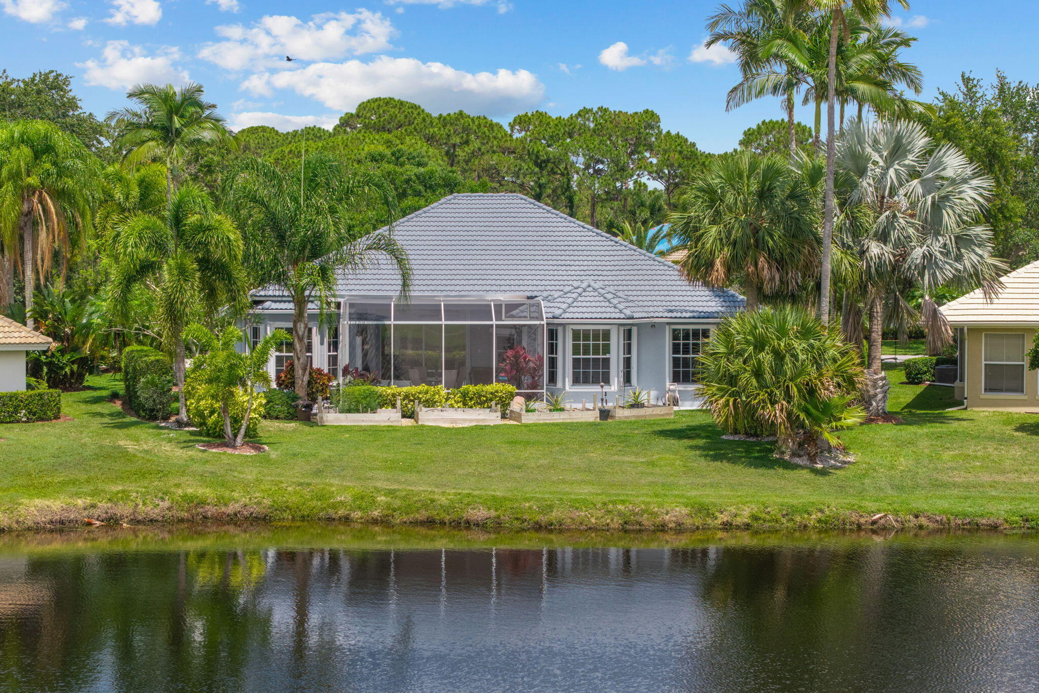 Welcome to Sanctuary Drive, of Country Club Estates. This home has a view! Sit on your patio and over look the water and the 18th fairway of St Lucie Trails Golf Course. Spacious open concept family room and granite kitchen with stainless appliances. Large primary suite with walk in shower, soaking tub, 2 walk in closets and dual sinks. 2 additional bedrooms and bath with 2 car garage. Upgrades include: Custom white Plantation shutters on windows, new garage door motor & chain w/ remotes, new 200amp service panel, Exterior of home has been painted including patio floor. Water heater new in 2021.