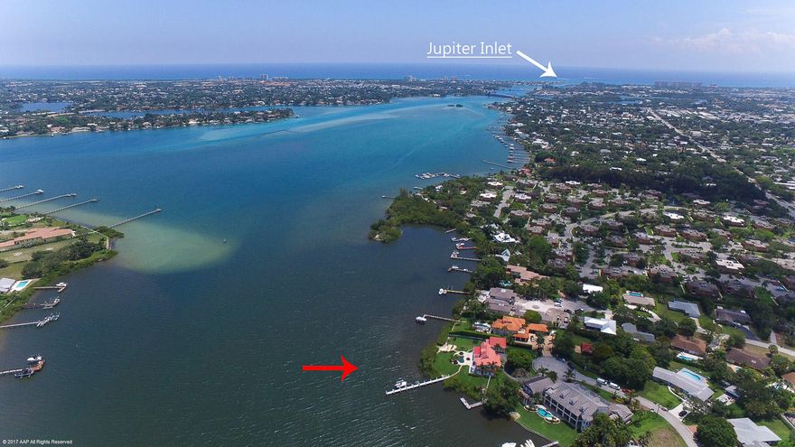 Discover one of the most beautiful lots on the Loxahatchee River. This one of a kind home features spectacular wide river views & breezes with 254 feet of waterfront. Lighted dock with boat lift. A walk in beach for kayaks or paddle boarding.  4 Bedrooms all with amazing river views with a extra room for an office inside the main house.  Additional 550sq ft office over the garage built in 2016.  5 1/2 baths including a full outside pool bath and an additional outside hot shower. Newly remodeled bathrooms in 2016.  Master bedroom complete with in cabinet refrigerator and carousel closet.  Family room is an entertainers dream with fire place, pool table and complete bar including sink, garbage disposal, ice maker and wine refrigerator.