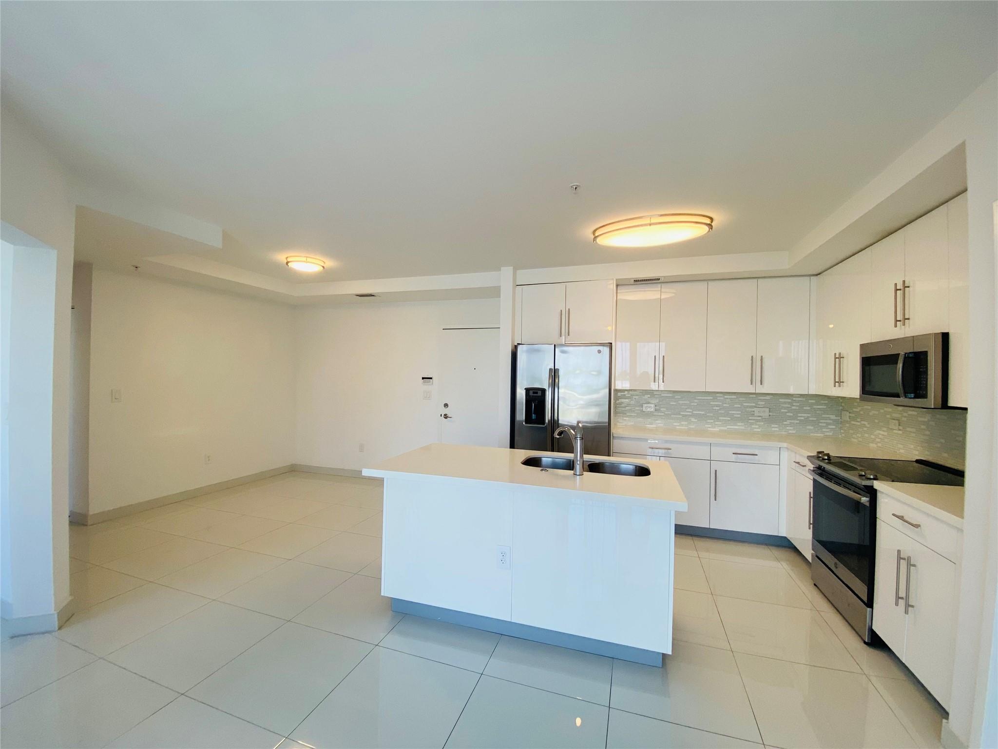 Luxury Condo in Aventura Place. 2 bed/2 bath + Den. 2 assigned parking spaces in open courtyard in the center of the complex. Luxury Italian kitchen with wood cabinetry, quartz counter tops, S.S. appliances, 24" porcelain white floors throughout, luxury vinyl just installed in the 2 bedrooms. Split floor plan unit with lots of natural light. 1 balcony where you can relax and enjoy beautiful sunsets from and a community pool. Walk in closets. Stacked washer/dryer included in the unit. High impact windows & doors. Walking distance from "Waterways", best public school in Aventura K-8 rated A school, House of Worship, close to Aventura Hospital and Aventura Mall, Gulfstream and US1. Brightline and Coastal Link, just a few steps away. Rent includes water, high speed wi-fi & 2 parking spaces.