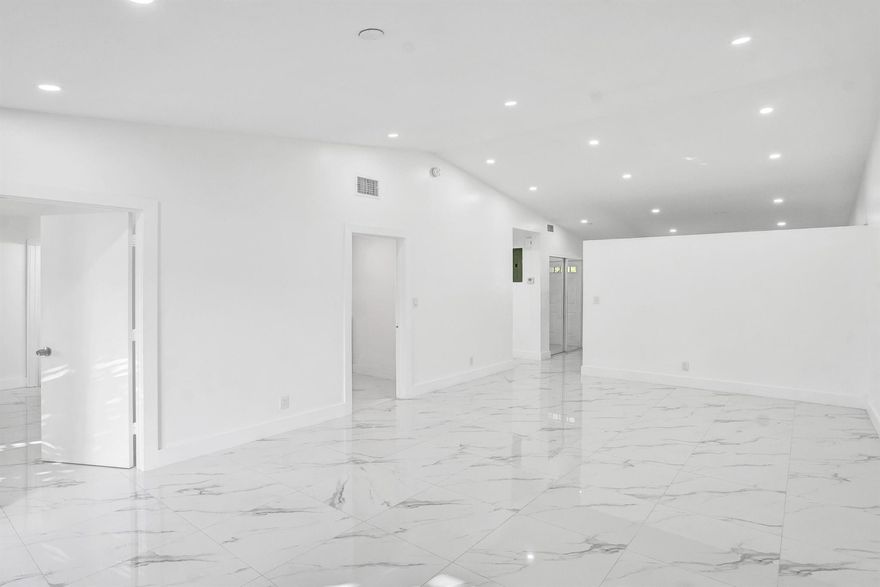 Beautifully renovated and move-in ready, this 2BR/2BA Deerfield Beach home features porcelain tile flooring, an updated kitchen with solid wood shaker cabinets and quartz countertops, and a bright open living area perfect for relaxation or entertaining. Both bedrooms offer generous space and walk-in closets, with the primary including a private en-suite bath. Additional highlights include an indoor laundry room with full-size washer and dryer, a fully fenced backyard with covered patio and storage room, a large driveway, and a charming front porch. Conveniently located near shops, dining, parks, major highways, and minutes from the beach, this home offers modern comfort in a prime location.