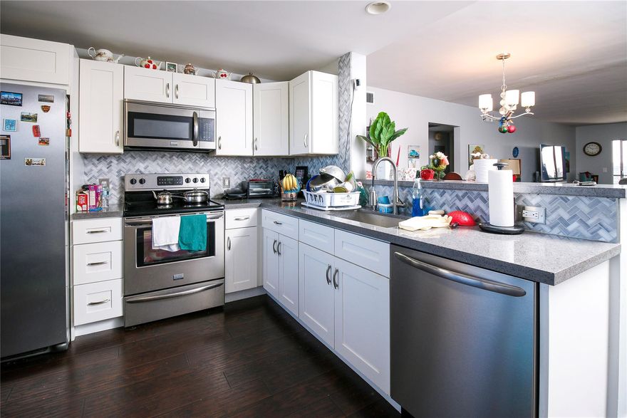 This charming 2-bed, 2-bath condo offers a truly luxurious living experience with its recent renovations and modern touches. The kitchen is stunning with stainless steel appliances, as well as gorgeous quartz countertops. With its open floor plan, the kitchen seamlessly blends into the living area, creating a spacious and inviting atmosphere.The entire condo boasts beautiful manufactured wood floors, and bedrooms are both spacious and comfortable. The renovated bathrooms are a high standard, featuring exquisite tile work and beautiful vanities.One of the features of this condo is the large screened-in patio, which offers breathtaking lake and golf course views The patio is also equipped with shutters, allowing added privacy and security. This is a 55+ community with lots of amenities.