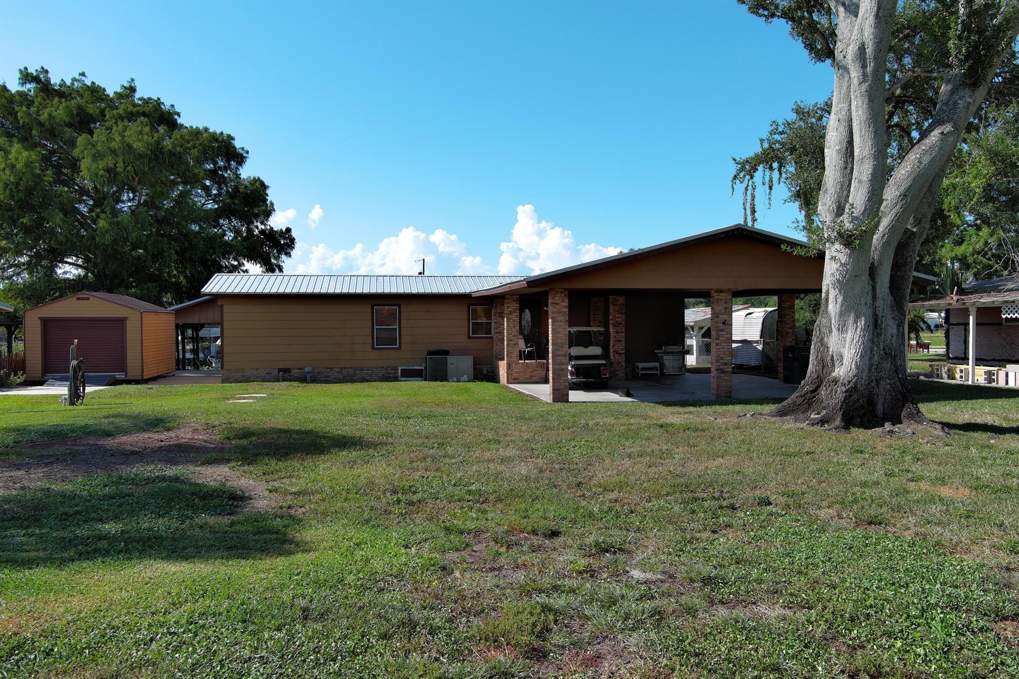Big Beautiful Brick & Cedar canal front home on .30 acres! Irresistible interior floorplan. Ideal location closest to the lock on Lake Okeechobee. Large front yard with double Covered Carport. New Boat Lift w/Slip for a 21' Pontoon or Bass Boat. Stong Seawall. You will appreciate the convenience of RV parking w/full hookups. Newer Roof, AC and HWT. Solid 10'x12' Shed w/ramp. Perfectly located Firepit. A large Propane Tank fuels Range and Outdoor Grill. The 28'x16' Great Room overlooks the water. Located in Buckhead Ridge, it's the perfect place to call home!