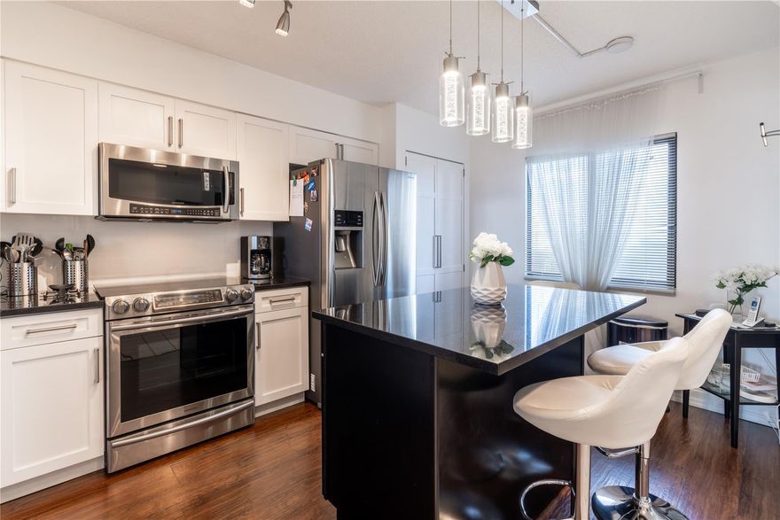 Price Reduced Again!!! Seller Motivated! Experience Stylish South Florida Living in this updated 2-bedrooms/ 2-baths condo in Cypress Bend featuring dual master suites, quartz countertops, All impact windows, and nearly 1,400 sq ft of open space. The modern kitchen includes top-tier appliances, an induction stove, Island, and large pantry, plus newer washer/dryer(2020) and A/C.(2021) Enjoy canal views, laminate wood floors, and resort-style amenities like Heated Pools, a Fitness center, Tennis, Clubhouse, Jogging Path and more...Close to Transit, Shopping, the New "Pomp"  development with Top Golf, Casino, Dining, and Shops and our Beautiful Beaches are just 10 minutes away! Pet-friendly; so bring your Pooch! and Furniture is negotiable.....Move right in and Enjoy! Seller's are relocating!