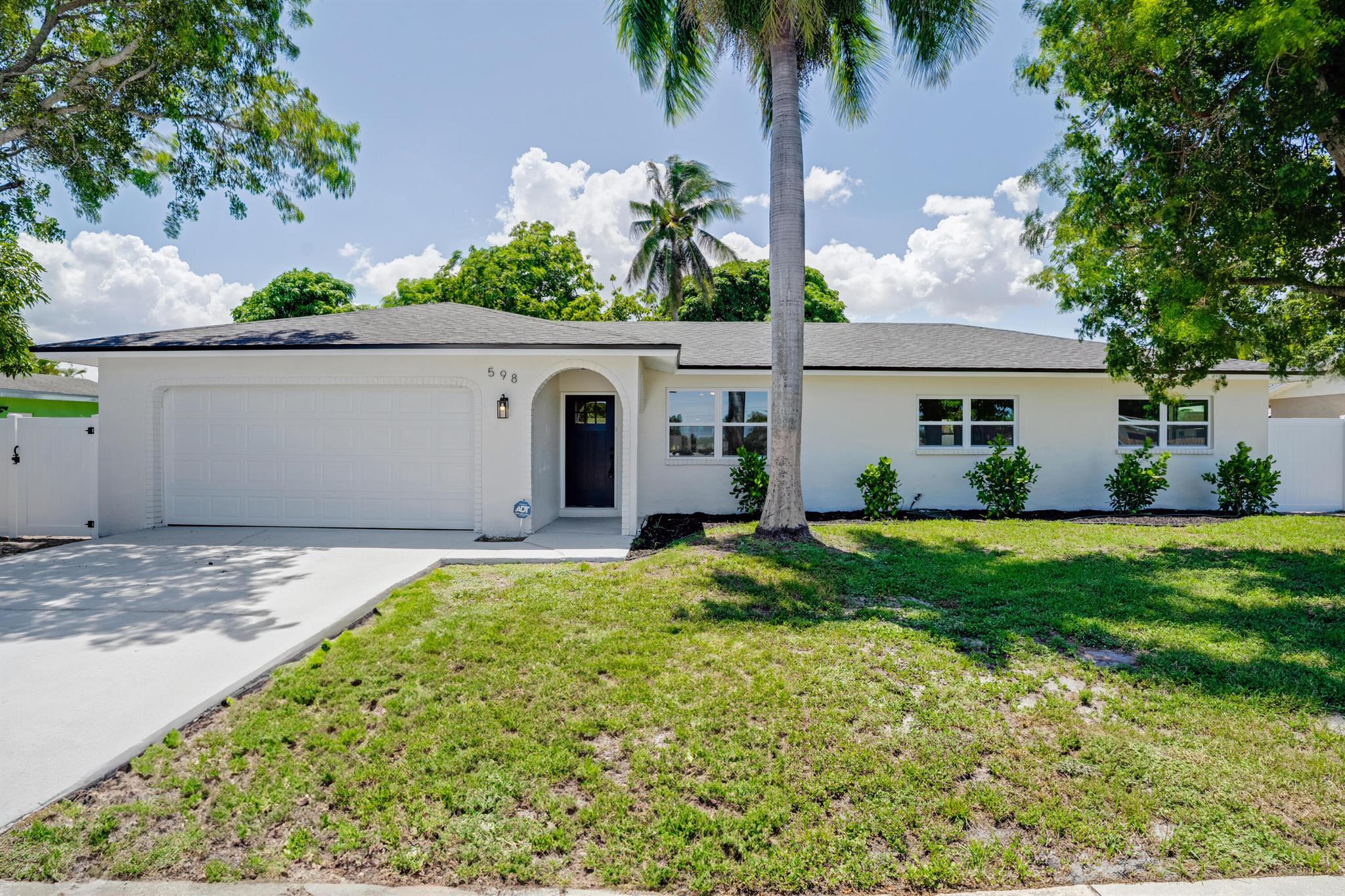 Fully Renovated No HOA Close to I-95Welcome to 598 Coral Way--a beautifully updated 3-bed, 2-bath home minutes from Downtown Delray and the beach. Located in a quiet, no-HOA neighborhood, this home features new luxury vinyl plank floors, knockdown ceilings, and an open layout. The redesigned kitchen boasts shaker cabinets, quartz counters, floating shelves, stainless Samsung appliances, and an undermount sink. Both bathrooms are fully remodeled with modern tile, black fixtures, and glass shower doors. Key upgrades: 2025 roof, new HVAC/ductwork, impact windows/doors, water heater, updated electric, attic insulation, new paint, stucco, lighting, epoxy garage, painted driveway, side gate/fence, and screened patio. Fully owned ADT alarm. Even the water heater and plants are new.