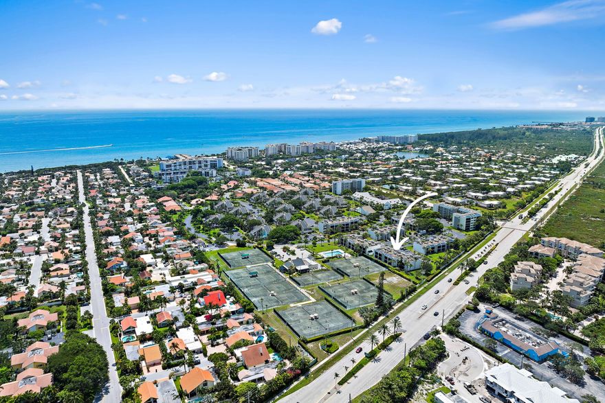 Enjoy this Stunning Highly Upgraded 1st floor corner condo with screened patio. Offering lovely garden and tennis court views. WALK TO THE Pet Friendly JUPITER BEACH! This one is SPECIAL..& Furbaby friendly. Walk to beach location+ close to restaurants, shopping, golf, theater and much more.Moments away from Jupiter's beautiful beaches, Harbourside Place, Riverwalk, restaurants, theaters and shopping. This one bedroom one and a half bath bright corner unit features stunning porcelain tiles throughout, recessed lighting, and multiple closets for storage! The updated primary bath offers a walk-in shower.