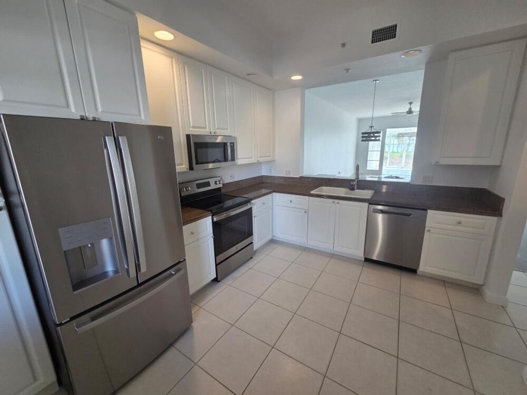 Photo of 23 Harbor Isle Dr Drive W #104, Fort Pierce, FL 34949 (MLS # R11165460)