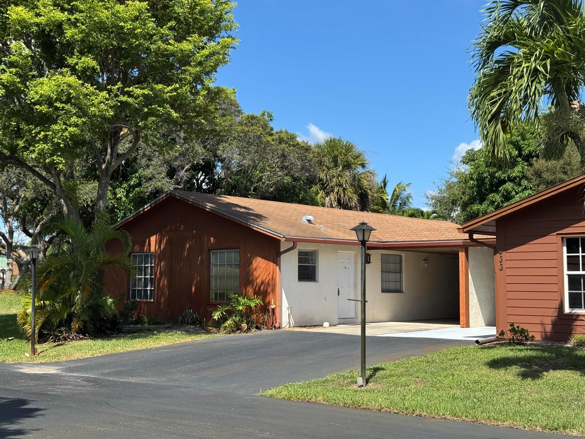 Renovated 2 bedroom and 2 bath villa ideally located in the all age community of Los Mangos. Located close to Downtown Delray and the beach! Spacious and open floor plan is light and bright. The kitchen was remodeled with white cabinetry, decorative backsplash, stainless steel appliances including high quality smart refrigerator. Tons of cupboard space with lazy susan corner for added storage space. AC unit is newly installed. Neutral tile in entry and kitchen and laminate flooring in bedrooms and living areas. Relax in your large screened patio overlooking the greenery views. Carport attached and laundry room with washer, dryer and storage. The current VA loan could be an opportunity to assume if qualified! HOA includes lawn care, irrigation, cable, internet and pool, etc.