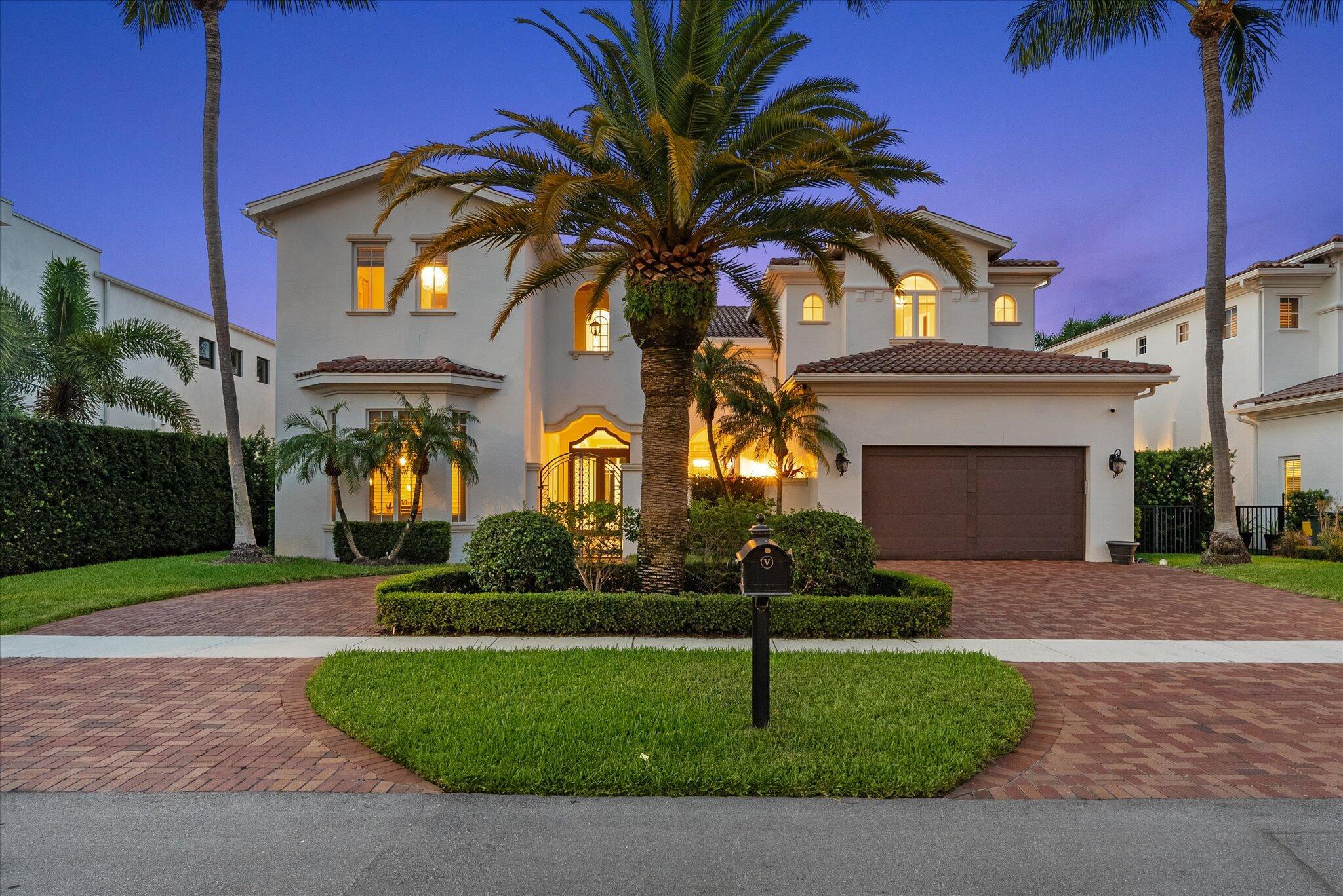 Situated in highly coveted Boca Villas, this 4,816 sq ft luxury residence offers 5 en-suite bedrooms, 5.5 baths, and a 3-car garage.The fifth bedroom thoughtfully designed to serve as a private office or study. A grand entry leads to a vaulted-ceiling living room with a striking fireplace, while the chef's kitchen features top-of-the-line appliances, custom cabinetry, and a spacious island ideal for entertaining. The primary suite is a serene retreat with a breakfast bar, spa-inspired bath, and private balcony. Step outside to enjoy a lush backyard with a sparkling pool, jacuzzi, and covered patio. Walk to Mizner Park, pristine beaches, fine dining, and boutiques, and experience the ultimate in elegant, walkable Boca Raton living.