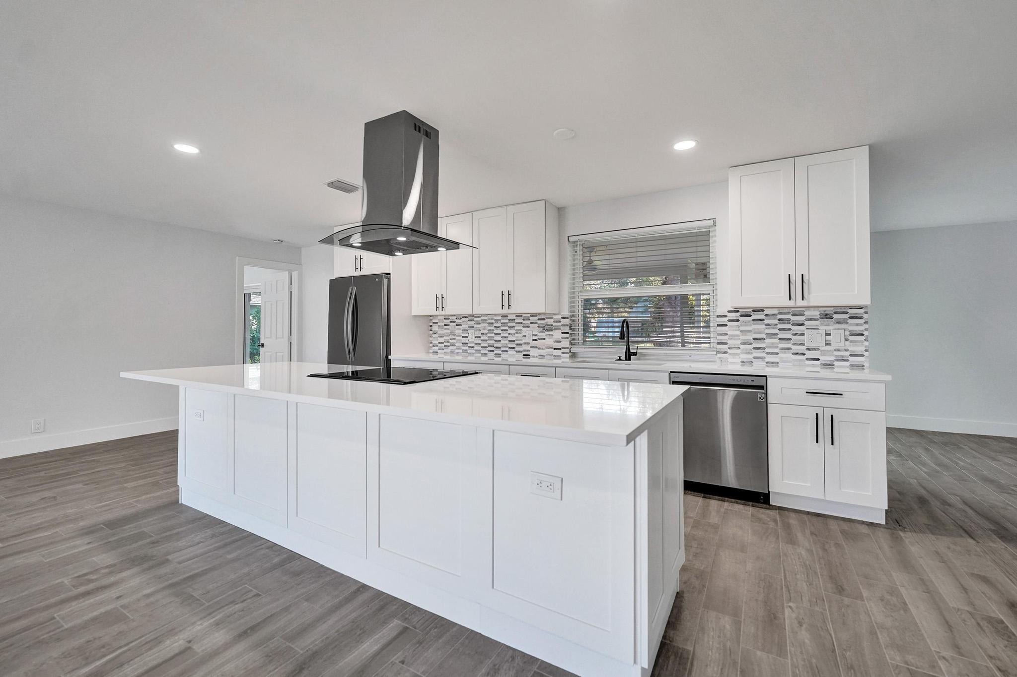 **Fully renovated + fully permitted = move-in ready perfection** This stunning 3-bed, 2-bath home in sought-after North Plantation Acres features an open layout with designer touches throughout—sleek quartz counters, brand-new cabinets, and premium stainless steel appliances. ALL NEW, Permitted 2023 roof, impact windows/doors, A/C, electrical, LED lighting offer modern comfort and peace of mind. Both baths shine with spa-style tile, frameless glass showers, and quartz vanities. Beautiful wood-look porcelain floors, modern fans, blinds complete the look. Enjoy a huge ¼-acre lot with a private yard, covered porch, and room for a pool. No HOA, 2-car garage, and prime location near parks, shops, dining, and major highways! Virtual pool/furnishings for inspiration. Laundry can move to garage.