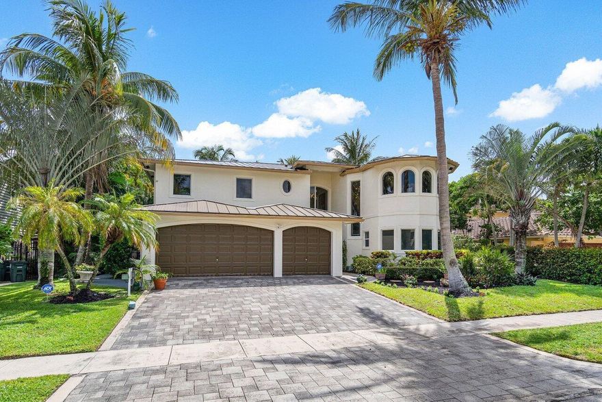 Escape to your waterfront oasis in the heart of East/Downtown Boca! Offering 80 feet of serene canal frontage with a 7,500lb boat lift and direct ocean access! This immaculately maintained home built in 2004 is your safe haven from any storm, with complete hurricane impact windows/doors/construction, a BRAND NEW metal roof, a Generac whole-house generator, and a back-up generator hook up! The three car garage includes a lift offering room for four cars, an electric car charger, and is completely tiled, insulated, and air conditioned. Inside the 4,462 Living Sqft is an inviting open floor plan with soaring ceilings and an abundance of natural light, highlighted by a first and second-floor primary suit.