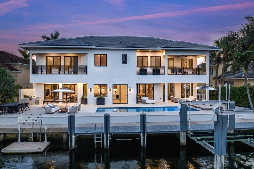 PRICE TO SELL -The furnished boaters' paradise that is 919 Jasmine Drive in Delray Beach invites you to embark on a journey of modern luxury and bespoke designer style, into an exquisitely reimagined waterfront haven that stands as a masterpiece of sophistication and comfort. Located directly on a canal and just minutes away from the beach, this meticulously crafted estate is COMPLETED AS OF 2021, and awaits as the perfect retreat for anyone looking to embrace the essence of waterfront living in South Florida. Set on a sprawling 90' lot with unobstructed water access and no fixed bridges, this 5-bedroom, 7-bath sanctuary in the beloved Tropic Isle Community unfolds across 6,038 square feet, 4,522 under air, unveiling a world of bespoke luxury.