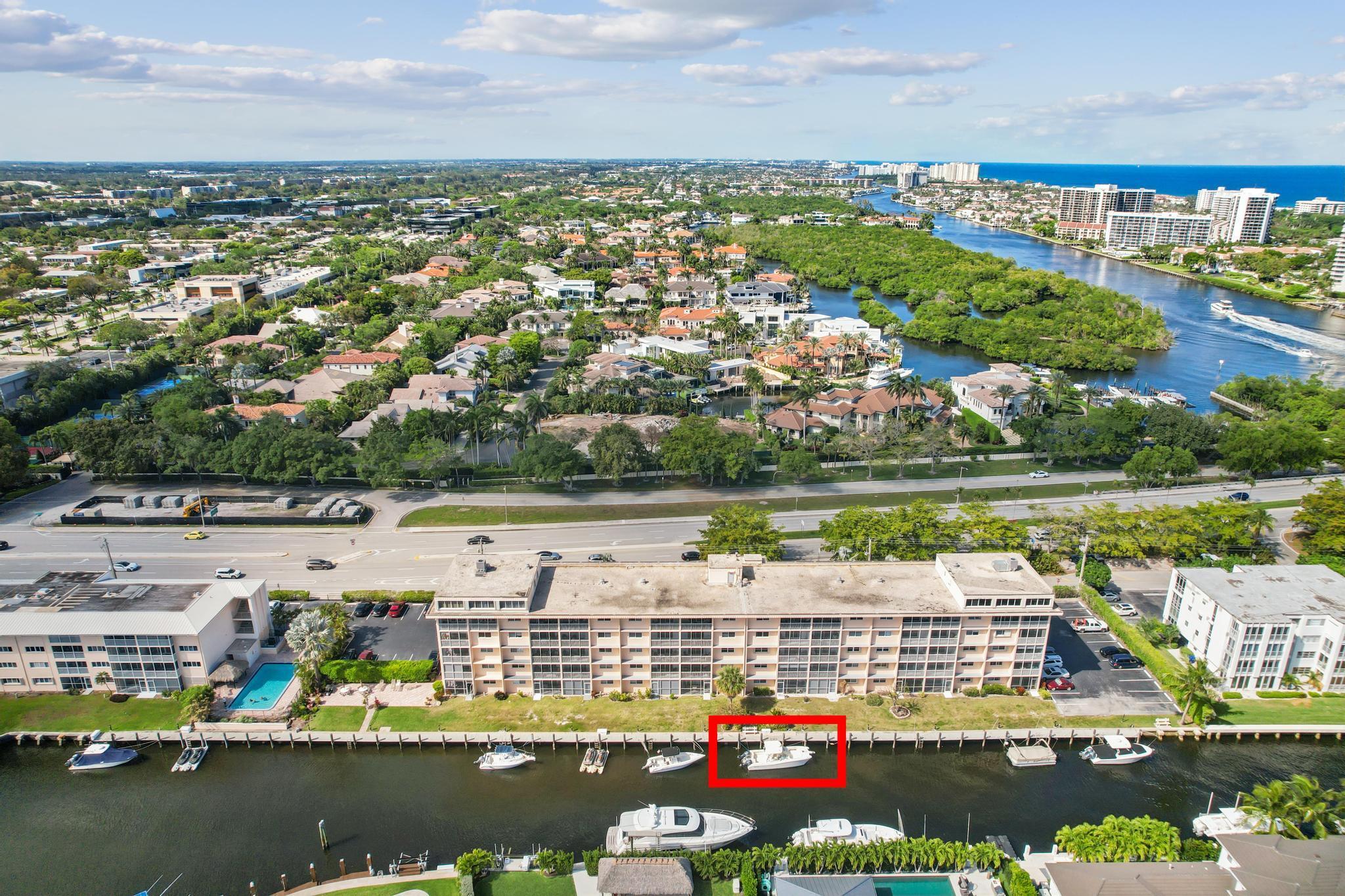 INCLUDES A DOCK! Discover your dream coastal escape with your very own 27' dock on Lake Rogers and the Intracoastal Waterway - a rare gem perfect for boating enthusiasts, with no fixed bridges on the short ride to the ocean. This fully remodeled condo combines modern elegance with beachside tranquility. Step into this beautifully designed ground-floor oasis featuring premium finishes throughout, just 0.4 miles from the beach. Enjoy a sleek kitchen, spa-like bathrooms, and impact windows that bring comfort and style. Unwind on the screened patio overlooking the water. Additional highlights include custom closet systems, a new AC, and storage. Located close to downtown Boca Raton and Mizner Park, this condo truly captures the essence of sunny South Florida living!