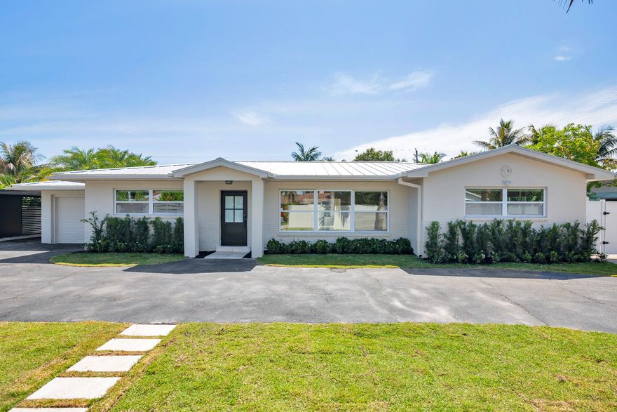 Spectacular, fully renovated, one-of-a-kind 4 bedrooms 4 full baths with one car garage pool home located in the highly sought-after lake community of Lake Clarke Shores—just one block from the public boat ramp! Bring your boat, jet skis, and enjoy the ultimate South Florida lifestyle in this beautifully updated 2026 residence. This exceptional home features a great layout and floorplan including a spacious primary suite and a secondary smaller junior suite overlooking the backyard—perfect for guests or multi-generational living. The interior showcases high-end finishes throughout, including a stunning backlit Cristallo backsplash, natural marble stone in all bathrooms, and elegant herringbone-pattern porcelain wood-look tile imported from Italy spanning the entire home. Additional  upgrades include a brand-new metal roof and natural skylight, filling the home with warmth and natural light. Gas connections are already in place in the backyard, offering the option to add a gas grill to your outdoor kitchen setup. Step outside to an incredible backyard designed for entertaining and relaxation. Enjoy artificial turf, easy to maintain a beautiful tropical foliage around a heated pool with a Jacuzzi, an oversized tiki hut, a fully equipped summer kitchen, and a cabana-style full bath. There is ample space on both sides of the property to accommodate a boat, jet skis, golf cart, or any other recreational toys. This home truly has it all—style, functionality, and an unbeatable location. You won't be disappointed—bring your buyers, this one will NOT LAST!!!