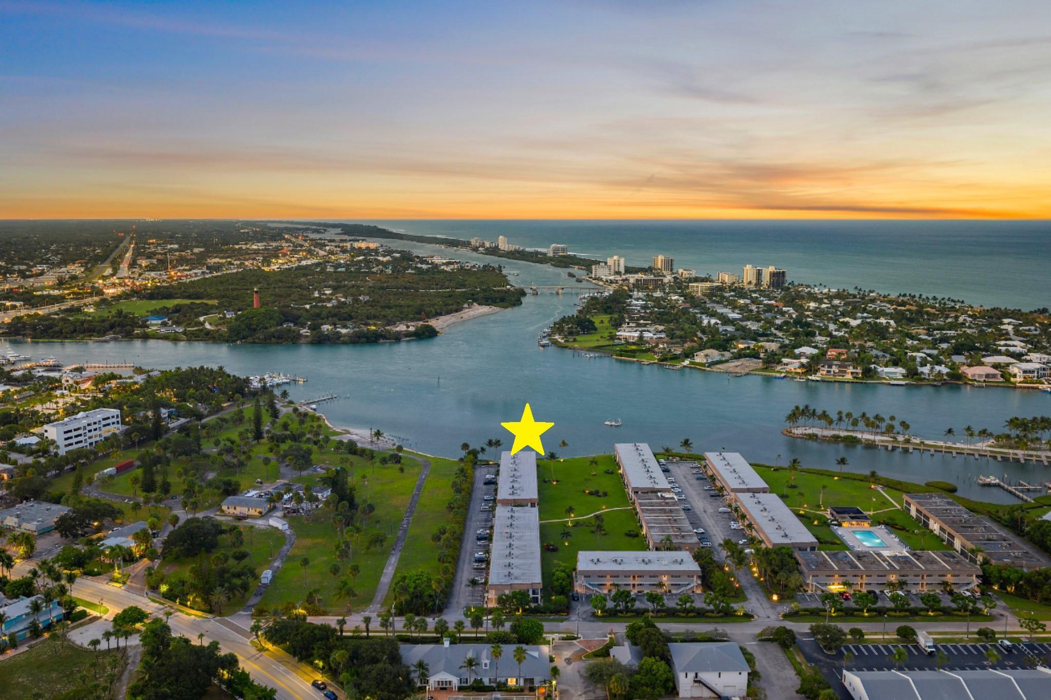 Looking for Million Dollar Views and ''Lock + Go'' convenience that is just around the corner from beautiful beaches, Jupiter's finest Waterfront Restaurants, shops, Boat Slips for lease, golf and more? This condo delivers all 3! Unrivaled Jupiter Lighthouse views + Unforgettable Lifestyle. Truly enjoy this completely renovated end unit with private entry and 180 degree views of the Jupiter Inlet. Entertaining is easy from the gorgeous kitchen that offers plenty of cabinet space, pots and pans drawer, Quartz counters, luxury appliances + breakfast bar. Wonderful open concept with ''Oak'' plank tile flooring, and Impact glass windows + doors that showcase the incredible view. Renovated baths are as pretty as a picture with high-quality tile work, walk-in showers w/ barn door enclosures.