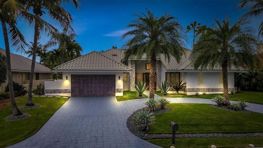 This slice of Paradise lets you enjoy both deep-water Boating and Beach lifestyles in this highly sought after Del Harbour neighborhood estate. A quick walk to Atlantic Dunes Park, a beautiful wooded oasis on a gorgeous stretch of sugar-sand beach and to Atlantic Avenue's restaurants and boutiques.  Plus, it's a short drive to all Boca Raton has to offer.
This tropical estate on 90 feet of water, features a 75-foot dock with 25,000-pound boat lift. Large window walls open the residence to the perfect outdoor entertaining area with covered patios. Wet bar, cabana bath, and a resort pool with rock waterfall. This single-story residence totals 4,468 square feet with spacious open living areas, 3 bedrooms, 4 full baths, and 1 half bath. The 2-bay garage with high ceilings and cabinetry. Inside the marble foyer are beautiful views open through the window-walled great room, which leads to the pool patio and features a coral-stone fireplace, custom built-ins, and wood-paneled ceiling.

There is a lush garden with koi pond. A breakfast area facing the pool, the gourmet kitchen includes custom Italian cabinetry, granite counters, a beautiful underlit onyx bar area. Encompassing the west wing, the private master suite opens to the pool and features custom built-ins, 2 walk-in closets, and a marble bath with spa tub. In the opposite wing is 2 more bedrooms with custom built-ins, walk-in closets and en-suite baths and another full bath for the office/den.