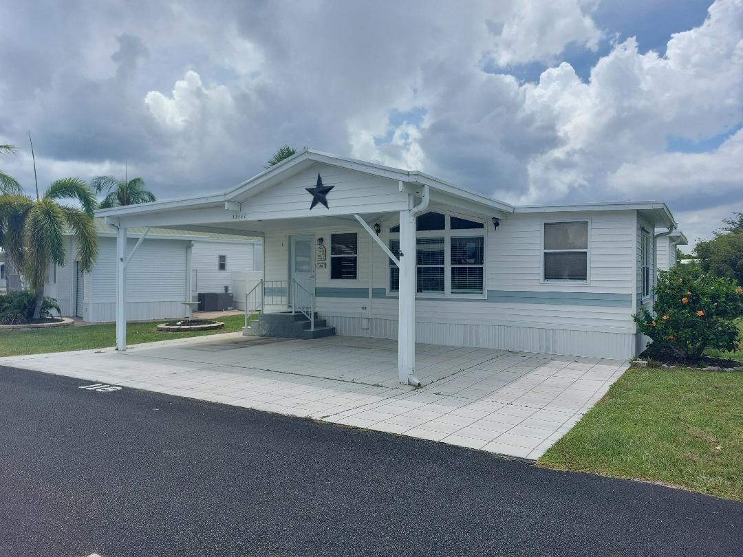 Highly motivated owner says bring all offers. This 2 bedroom waterfront home has a dock off the screened porch. This home has been lovingly maintained and is being sold mostly furnished. Blue Cypress Golf and RV Resort is an active retirement community, 55+, and has lots of activities. There is a 9 hole golf course, fishing, beautiful pool and new pickleball court. The community boat ramp takes you to Lake Okeechobee. Many activities include bingo, card games, etc. Homeowners fee of $240/month pays for water, sewer, trash, recycling. All measurements are approximate, must measure for exact.