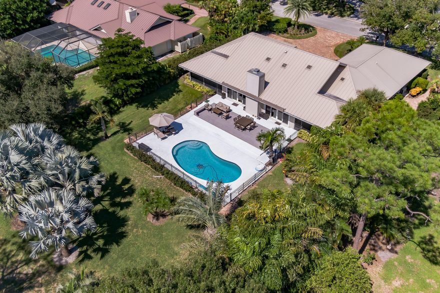 New Price Improvement on this beautiful home in Mariner Sands Country Club!  New impact windows & doors installed in 2022!  The oversized patio, recently resurfaced pool & spacious backyard offer serene tropical views of mature palm trees & the 17th fairway of the Gold Course. The large gourmet kitchen features a commercial sized refrigerator, double ovens, granite countertops, & custom wood cabinets.  It opens to an inviting family room with a custom bar and fireplace, perfect for entertaining.  Other features include metal roof, heated pool, fresh interior paint, newly remodeled bathrooms, custom walk-in closets, gorgeous wood floors, large retractable awning, screened patios off both the master and guest bedroom, separate living room, 2 car plus golf cart garage. Mariner Sands has a resort-style pool, lap pool, Har-Tru tennis courts, pickleball, two 18 hole championship golf courses, croquet, incredible fitness center, restaurants, club house, 24-hour manned guard gate.

Social membership required, capital contribution of $30k due at closing. Golf membership is optional.