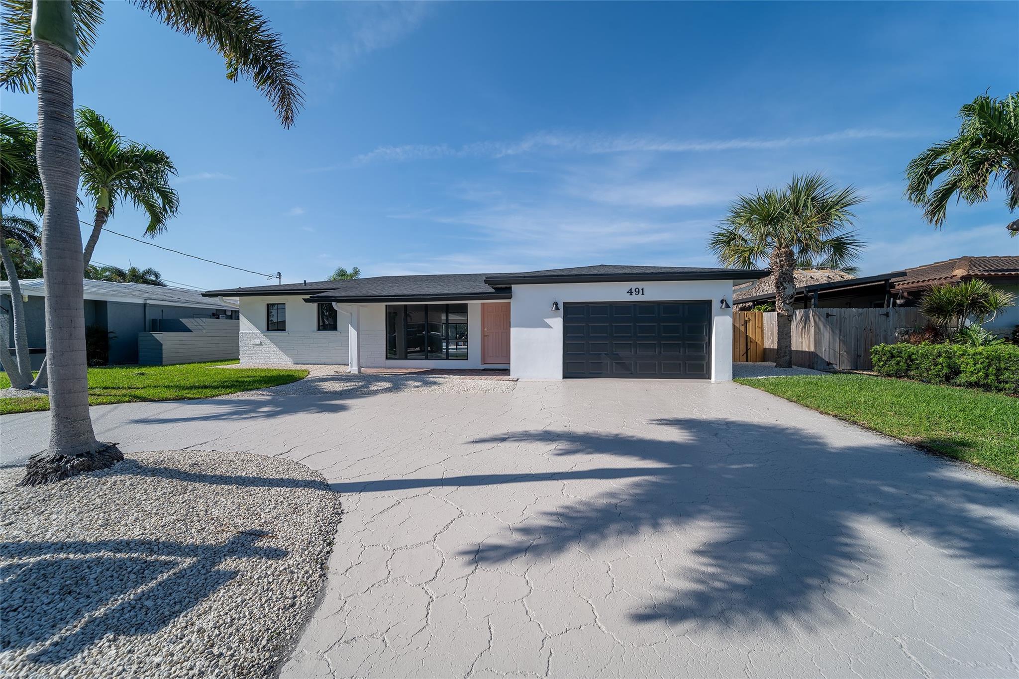 Paradise is calling…ocean access home with 70ft of water frontage in the popular boating community of Garden Isles in Pompano Beach. Interior features include light, bright open floor plan w/ direct pool and waterfront views, polished Terrazzo & plank ceramic tile floors, white kitchen cabinets, stainless steel appliances, separate laundry room with extra storage. Exterior features include oversized 1-car garage, circular driveway, pool deck with extra space for outdoor kitchen or tiki bar, 50ft boat dock, fenced in backyard, NEW roof in 2023 and much more. Located on quiet cul-d-sac street easy & just 5 mins to the beach Walk, bike, boat or golf cart to new restaurants & local attractions. Possible Seller financing with excellent terms. $15,000 Buyer Credit for new windows. Call today!