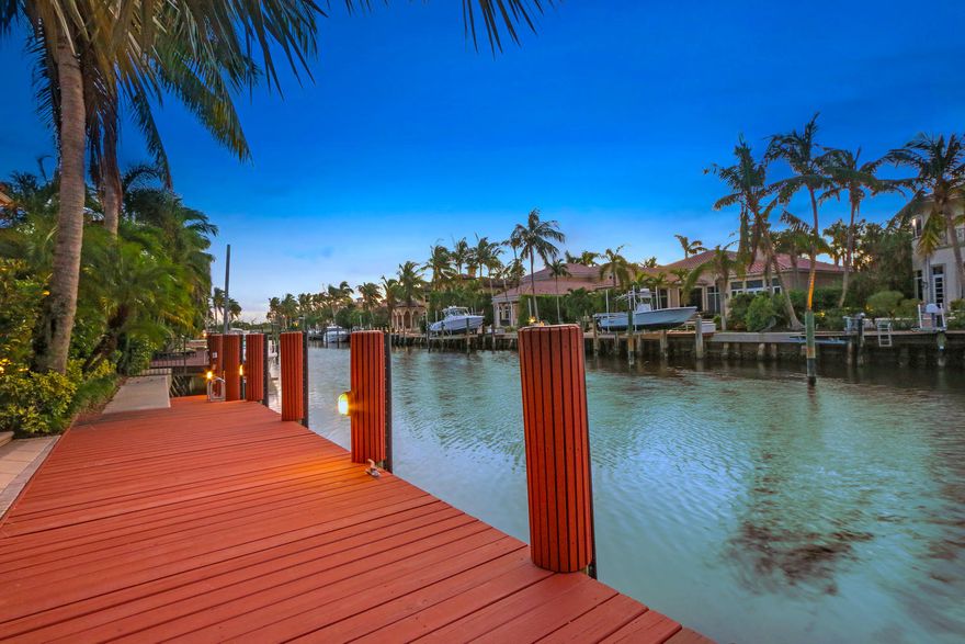 REDUCED $100,000! MASTER ON THE 1ST FLOOR + another 1st floor En-Suite Bedroom and 1st Floor Magnificent office. IMPACT GLASS and Concrete Block construction.  This spacious custom estate has been immaculately maintained and is ready for your yacht in the backyard...6 HOUSES FROM THE INTRACOASTAL and NO FIXED BRIDGES.   16,000 lb Dock with Lift in place + 2nd lift.  Floor plan is conducive for entertaining with 5 bedroooms, 7 full baths and 1 half bath PLUS a  large expanded loft/game/family room area upstairs.  Customized kitchen with state of the art appliances and breakfast bar.  Large center island and plenty of prep space. Custom cabinetry abounds and enhances the home. LOW HOA fees($417/mo). An excellent value in this intimate Boaters Enclave..a true hidden gem