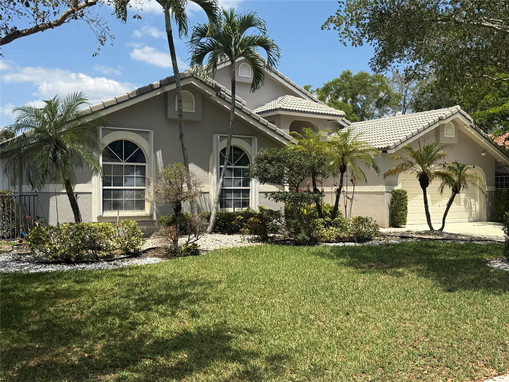 Absolutely stunning 5-bed, 3.5-bath pool home with water views in the guard-gated Eagle Trace community. Built in 1991, a 2024 appraisal confirms 2,654 sq ft under air (tax records show 2,413 sq ft). Well maintained and equipped with two AC units for comfort and efficiency. Set on an oversized lot with no rear neighbors, this natural light home features vaulted ceilings, a split floor plan, and a remodeled kitchen with granite counters, wood cabinets, and stainless steel appliances. The spacious primary suite offers a walk-in closet and a luxurious bathtub and separate shower with dual sinks. Includes formal living and dining areas, updated guest bath, accordion shutters, and ceramic tile in main areas. Relax by the tranquil pool with peaceful water view—perfect for entertaining.
