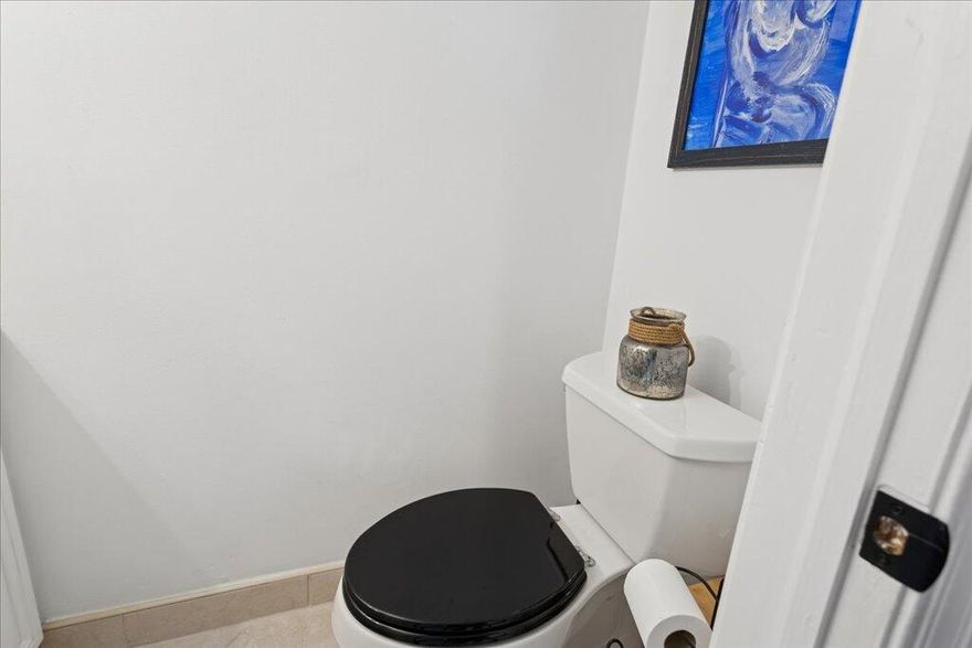 This second floor townhouse style is one of the LARGEST 2 bedroom, 2.5 bathroom condos on the market.  The END unit provides privacy. This homes offers many updates and a pre-inspection report. A buyer is sure to be impressed! Upon entering, you'll feel like you are in a luxury townhouse without the high HOA fees. The designer touches are top to bottom. The electrical was updated, the A/C & water heater. New bathrooms, new kitchen appliances, new fixtures/fans- even the base boards! The second floor has luxury engineered wood flooring and floor-to-ceiling windows in the master bedroom.  Master bedroom can be divided into two spaces to accommodate an office. A private screened balcony overlooks the garden. Hurricane shutters complete the package. Ask your lender- 5% down finance options!