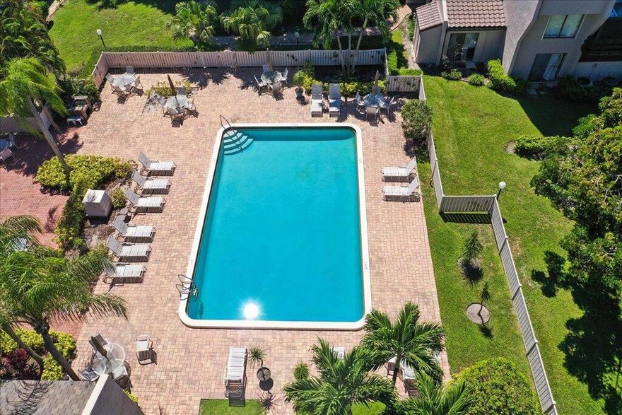 This second floor townhouse style is one of the LARGEST 2 bedroom, 2.5 bathroom condos on the market for the price.  The END unit provides privacy. This homes offers many updates and a pre-inspection report. A buyer is sure to be impressed! Upon entering, you'll feel like you are in a luxury townhouse without the high HOA fees. The designer touches are top to bottom. The electrical was updated, the A/C & water heater. New bathrooms, new kitchen appliances, new fixtures/fans- even the base boards! The second floor has luxury engineered wood flooring and floor-to-ceiling windows in the master bedroom.  Master bedroom can be divided into two spaces to accommodate an office. A private screened balcony overlooks the garden. Hurricane shutters complete the package.