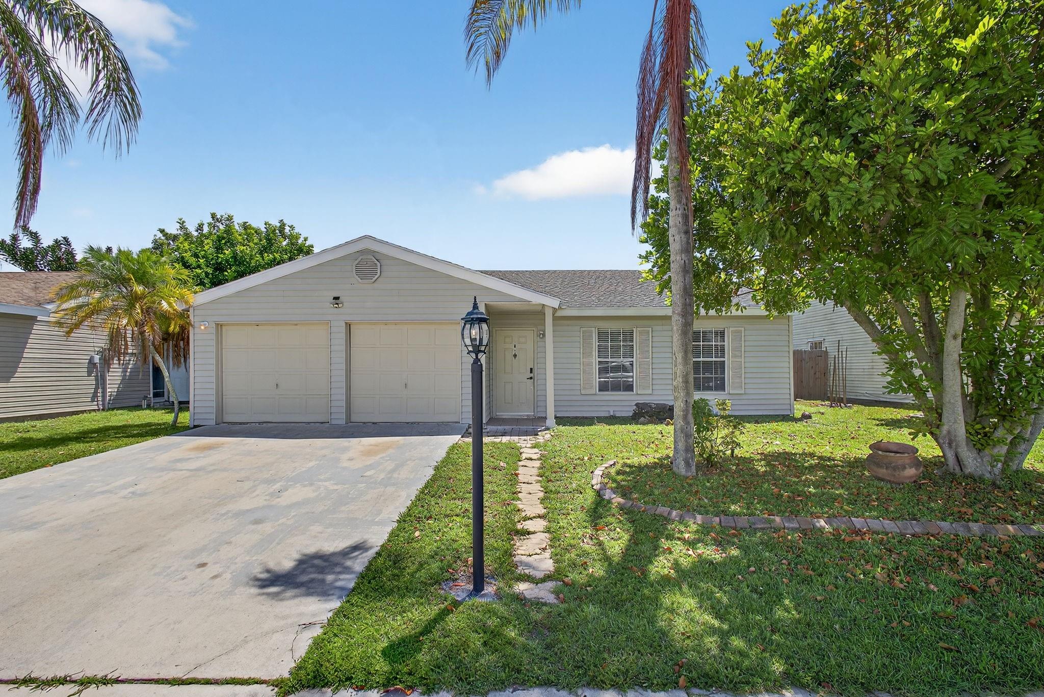 This beautifully remodeled 3-bedroom, 2-bath pool home features a bright, open kitchen with stainless steel appliances. Step outside to your own private screened pool and patio area - perfect for entertaining. Complete with a safety fence and a fully fenced yard ideal for pets. The split-bedroom layout offers waterproof luxury vinyl flooring throughout, a spacious primary suite with a large walk-in closet, and a sleek master bath with a walk-in shower. The guest bath includes a relaxing tub. The oversized two-car garage houses a full-size washer and dryer. Located in an all-ages community of single-family homes within a top-rated school district, you’ll be just minutes from Wellington, major highways, parks, beaches, and airports. Pool and landscape service are included.