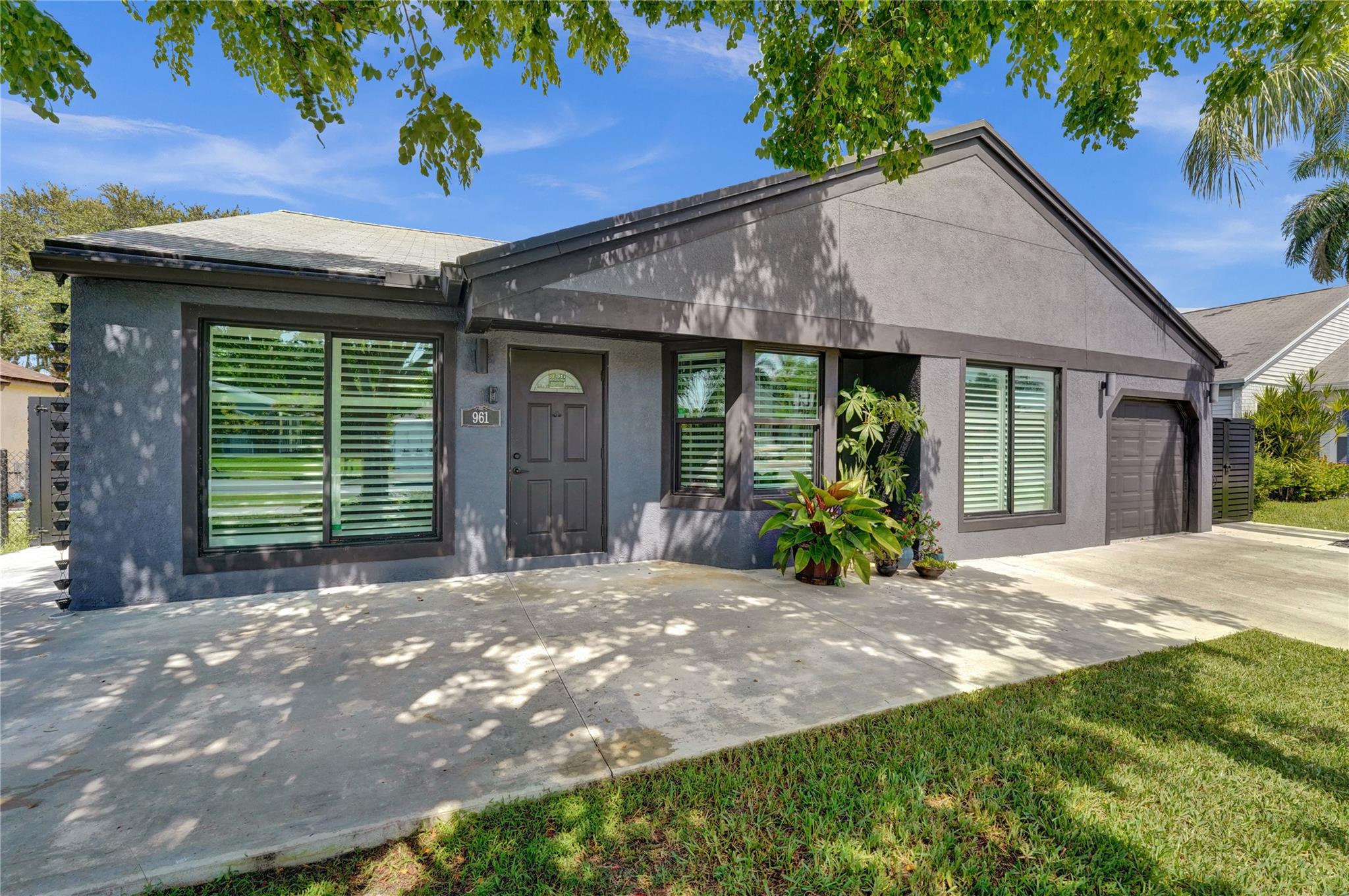 Enjoy peace of mind and style in this beautifully upgraded home featuring a fresh stucco exterior, impact windows and garage door, a large front patio, and a fenced yard with serene lake views. The kitchen includes modern appliances and a stylish backsplash. A bonus room off the kitchen offers flexible space for a home office, dining area, or playroom, while another bonus room behind the primary bedroom is ideal for a private retreat, nursery, or oversized closet. The home is EV charger ready. Additional highlights include energy-efficient lighting, ample storage throughout, and easy access to nearby parks, shopping, top-rated schools, and all major highways—making it a perfect place to call home. Seller is also providing a warranty through American Home Shield, adding extra peace of mind.