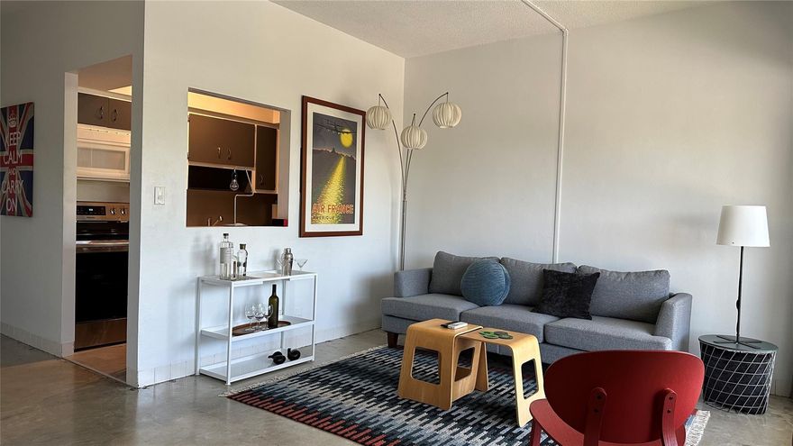 Airy and bright 1 BR condo in a distinctive mid-century Wilton Manors building! One of only 12 units in assoc, this top floor home shines with polished concrete flrs, 9-ft ceilings and a wall of windows. Updates incl: 2  Mitsubishi mini-splits, new elec panel, impact windows & doors, new appliances, & water htr. Lean into the original MCM vibes, or update finishes to suit your taste. Parking for one vehicle, plus plenty of guest spaces. Building offers on-site laundry + unit has an XL storage closet. Super convenient location provides easy access to Wilton Drive, I-95, airport, & FTL beach. Reasonable monthly maint of $459. New roof in '25. Assoc is current with all required inspections, reserves are fully funded. NO HOPA/NO Land Lease/NO REC Lease! CASH ONLY. Owner is FL licensed RE agent