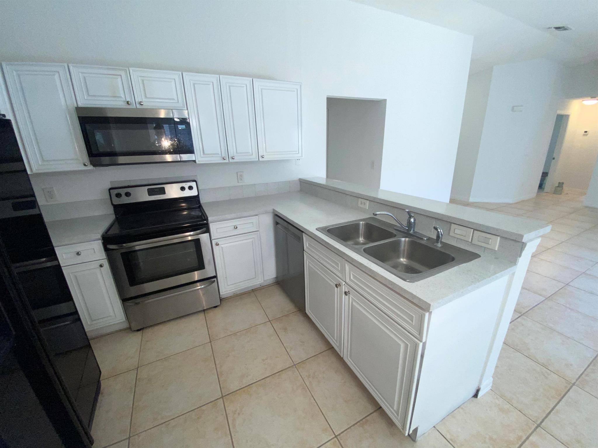Come see this 4/Four Bedroom 2/Two Bathroom Corner Apartment home. Sits on Duplex Lot. All Tiled Flooring. White Open Kitchen Style with a Huge Living Area. Nice size parking can fit 2 large vehicle or 3 small. Ready to Move In. Ideal local landlord. Lawn is included in rent. Pet friendly.