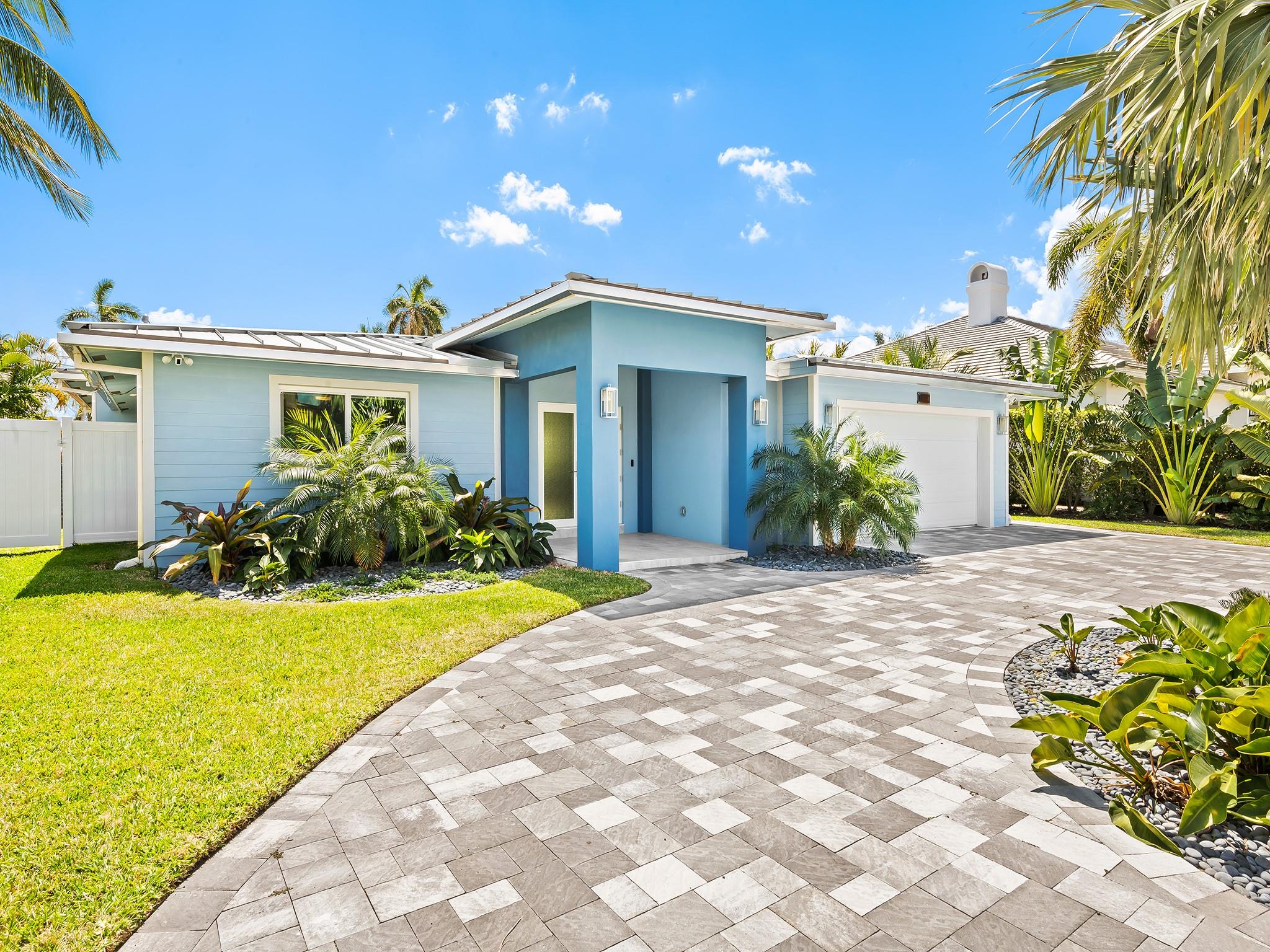 Welcome to this beautifully remodeled 3-bedroom, 3-bathroom residence in the highly sought-after Lake Placid subdivision of Lighthouse Point. Spanning 2,693 sq ft of living area, this open-concept home boasts porcelain tile, and LED recessed lighting throughout. The oversized kitchen features a Wolf gas stove, dual Bosch dishwashers, custom wood cabinets, quartz countertops, and a large pantry. Enjoy a bonus room, walk-up bar with a wine cooler, and a fenced backyard with a covered patio prepped for an outdoor kitchen. Upgrades include a new metal roof (2024), impact windows, new PVC piping, updated electrical panel and a 50 AMP car charging outlet. A must see! Beautifully renovated, feels and lives like new construction!