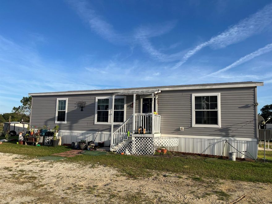 Don't miss the opportunity to own 5 acres featuring a 2020 double-wide mobile home with 3 bedrooms, 2 bathrooms, and 1,303 square feet of living space. The property includes three separate entrances and currently carries an agricultural exemption, keeping taxes low. It also holds a licensed farm designation, allowing for pole barns, animal structures, RV or container storage, and more. Consisting of four 1.25-acre lots--three on 310th Street and one on 308th--the third lot on 310th has its own entrance gate, culvert, and filled house pad ready for an additional home. A 48 x 60 barn with a 14-foot center height and 11-foot sides features aluminum trusses built to last a lifetime. The property is fully fenced and cross-fenced, with multiple sheds, storage buildings, a chicken coop, and