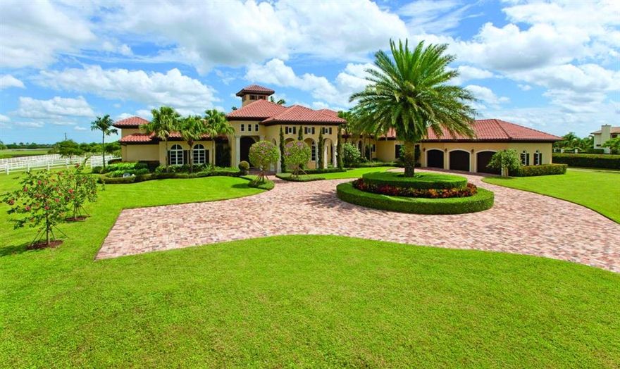 Inspired by breathtaking Tuscan architecture, this beautiful equestrian courtyard property is meticulously landscaped, featuring lush gardens, waterfalls, fountains and statues. Ideally located on the equestrian trail and nestled between polo fields, this 5.2 acre property offers serene privacy, with breathtaking views from every window. The barn was designed with the well-being of both horse and rider in mind and there is no doubt that this farm is one of the finest properties in Wellington!
