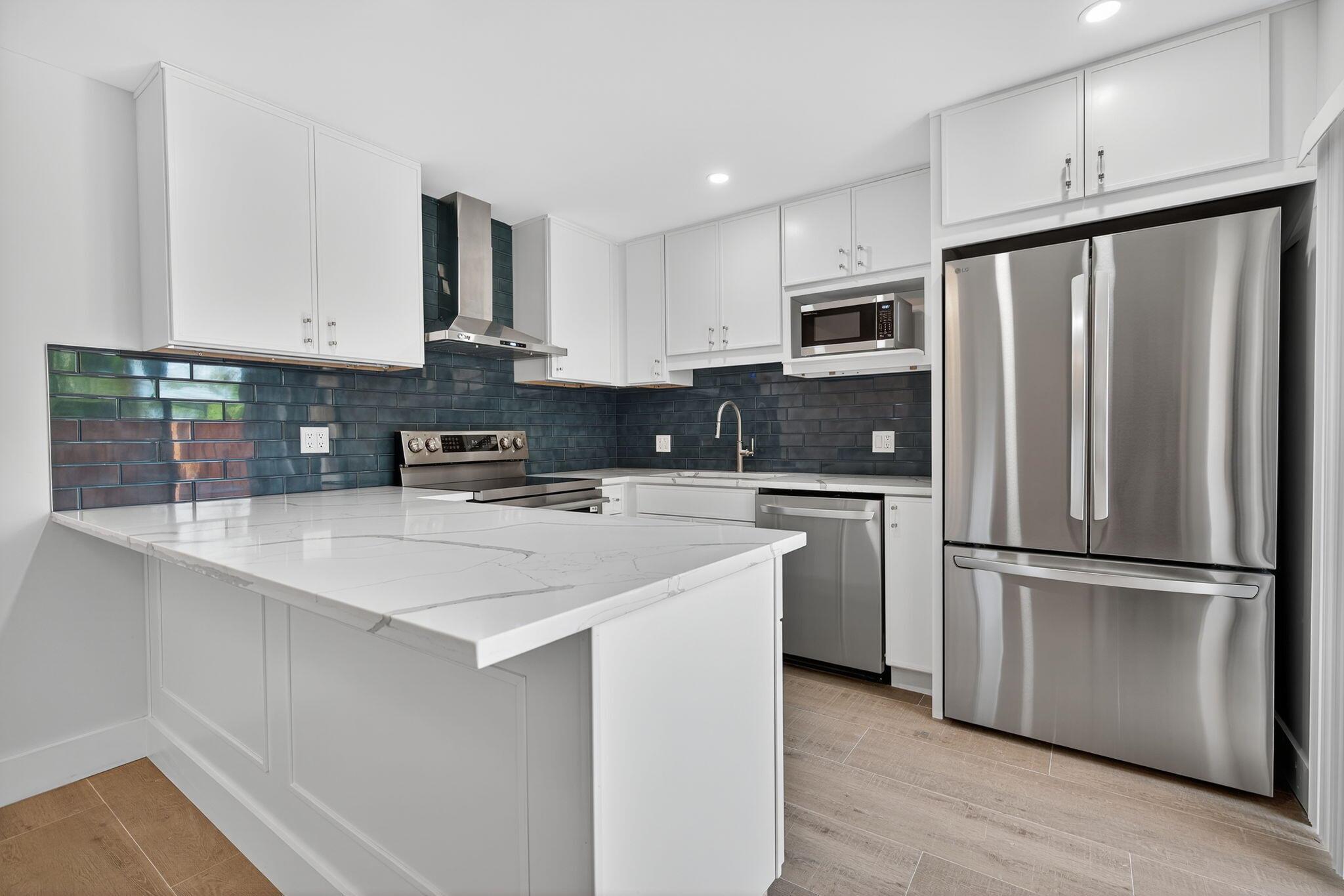 Experience fresh, modern living in this fully renovated 2BR/2.5BA Tequesta Hills townhome. Features include high-hat lighting, tiled powder room wall, built-in wine fridge, expanded master shower with custom cabinetry, and porcelain wood plank tile throughout. The kitchen offers quartz countertops, stainless appliances, and micro-shaker cabinets; baths feature designer tile and fixtures. Fenced courtyard (BBQ ok), washer/dryer, assigned parking, and community pool. Across from Constitution Park with tennis, pickleball, and playground. Enjoy Tequesta's coastal charm, boutique shops, cafes, and nearby Jupiter beaches. Annual lease; pet considered.