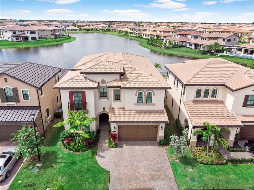 This beautiful Wilmington model is located on a prime water lot with over $80,000 in recent improvements including a new kitchen with custom Italian cabinets, quartz countertops, Carrera Marble backsplash,  professional grade SS Viking appliances and a center island with pendant lighting! Other features include Electro Lux washer & gas dryer,  upgraded carpeting & 20" tile flooring, a huge 19 x 12 loft, designer window treatments, built-in closets in all the bedrooms & a tandem 3-car garage! Enjoy the covered lanai with 3 phantom screens, a remote control louvered pergola, summer kitchen, gas heated salt water sport pool, tropical landscaping and stunning water views! This community offers amazing amenities with low HOA fees & great area schools! South Florida Living at its best!