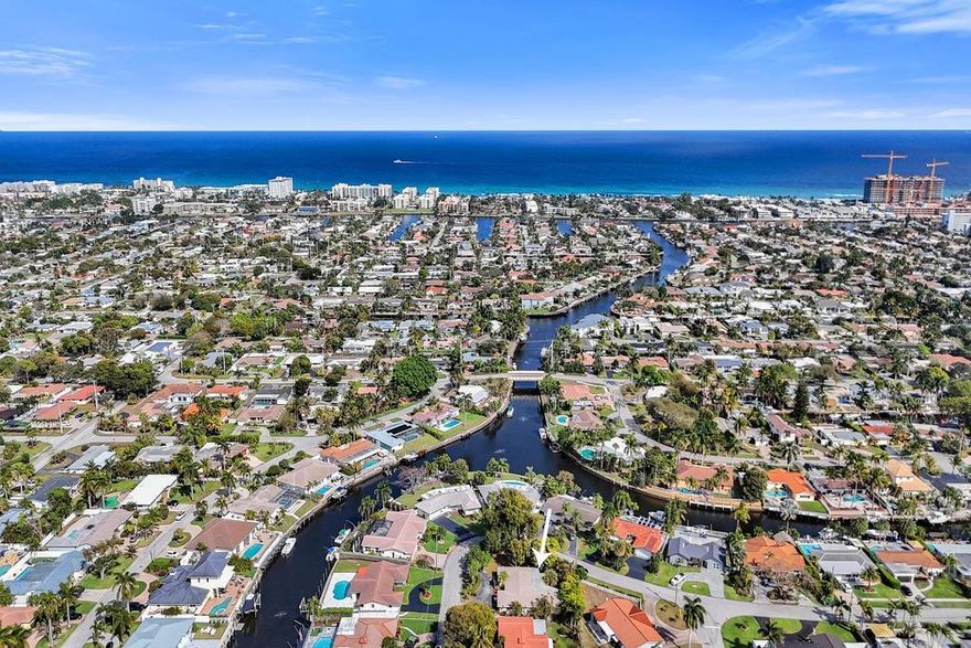 Located in the desirable neighborhood of THE COVE, this 3/2 home is ready for your customization. Huge corner lot on private, quiet street. Split floor plan allows for privacy. Brand new 2025 roof. Walk into expansive living room overlooking large, screened lanai. With almost 1900 s.f. under air, plus a true two-car garage, this is not your typical East Deerfield Beach home. Plenty of room to expand on the lot or even add a second story. 2020 A/C, 2021 H/W Heater. Circular driveway w/plenty of parking. Create your own masterpiece here. No HOA fees or hassles! Perfect location in the Cove; minutes to Sprouts, Target, The Cove restaurants and shops. Or bike to the renowned beaches of Deerfield Beach. Location, location, location!