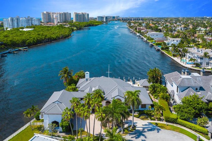 The pristine waterfront community of Boca Bay Colony is the luxury backdrop for this sprawling estate perched on a prized (and oversized) Intracoastal point lot. With more than 270 feet of direct Intracoastal wraparound frontage and deep-water dockage, the property is a boater's paradise in every conceivable way, right down to the unique breakfront pilings that are exclusive to this address. 
 
Situated on a quiet cul-de-sac, the 10,192-square-foot home (more than 7,022 square feet of which is under air) features six bedrooms and 6.5 baths with soaring ceilings and panoramic waterfront views throughout. The estate has been reimagined with custom-designed finishes, marble flooring and many other upgrades. The spacious second-floor master suite overlooking the Intracoastal feels like its own great escape and includes an expansive patio to enjoy your morning coffee. 
 
Beyond its inviting open spaces, perfect for entertaining, the property also includes a separate guest house with private entry, kitchenette and laundry room for guests or live-in staff. The circular driveway leads to a large three-car garage, presenting the possibility for multiple car lifts for auto enthusiasts to maximize their collection.

Situated on one of the most prized intracoastal trophy point lots in Palm Beach County, this sprawling property epitomizes waterfront living at its finest.