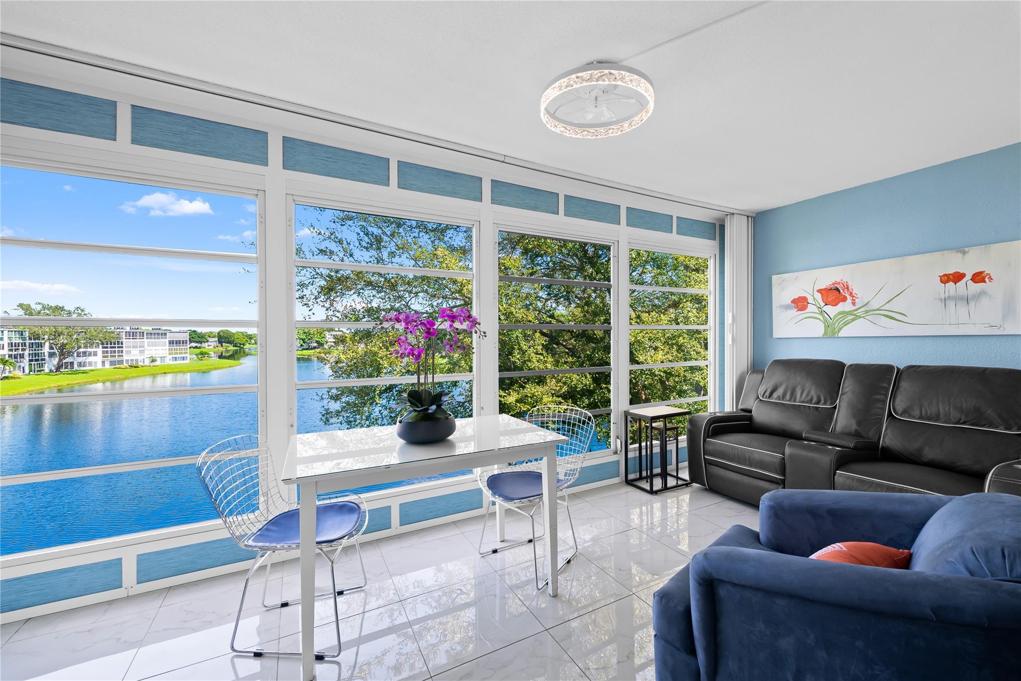STUNNING WATERFRONT CONDO – FULLY UPDATED 1BR/1.5BA WITH INCREDIBLE VIEWS! Beautifully updated 4th-floor 1-bedroom, 1.5-bath condo with expansive water views in the sought-after Century Village 55+ community. This unit features a modern open-concept kitchen with wood cabinetry, tiled backsplash, and newer appliances. Tile flooring throughout, updated A/C and water heater, and stylish new furnishings included. Spacious enclosed patio offers a perfect space to relax or entertain while overlooking the serene water. Located in a well-maintained building just steps from the clubhouse. Enjoy resort-style living with amenities including a clubhouse, heated pools, tennis courts, billiards room, fitness center, and complimentary bus service. Conveniently close to beaches, shopping, and restaurants.