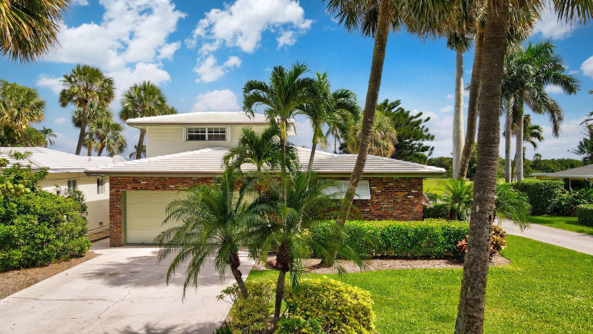 Beautiful 4 bedroom, 3 bathroom, golf course home on a corner lot in the charming historic district of East Lake Worth Beach. Enjoy expansive golf course and Intracoastal views from this well-maintained residence featuring over 2,000 sq ft of living space, an updated kitchen, original oak wood flooring, and a 2 car garage. The bright, spacious interior offers a functional layout, ideal for both comfortable living and entertaining. Located just minutes from the vibrant downtown district, you're a short walk or bike ride to eclectic shops, local cafes, art galleries, and the beach. Known for its coastal charm, walkable streets, and lively community spirit.