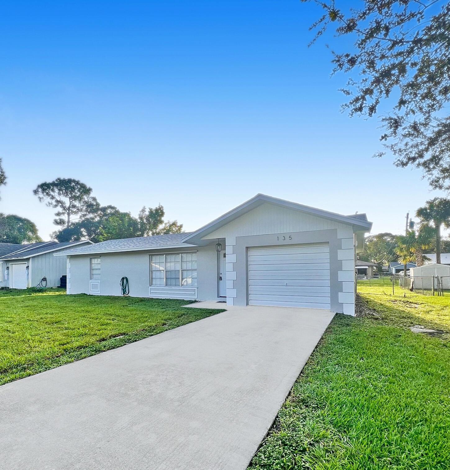 Spacious and newly renovated 2 bedroom, 1 bathroom, and 1 car garage home with screened patio and enormous fenced backyard. Open floor plan with neutral color palette flooded with natural light. Wood plank ceramic tile throughout. Beautiful crisp, white kitchen cabinets with natural stone counters and stainless steel appliances. Front loader washer and dryer with extra storage in the laundry room. Storage shed in backyard.