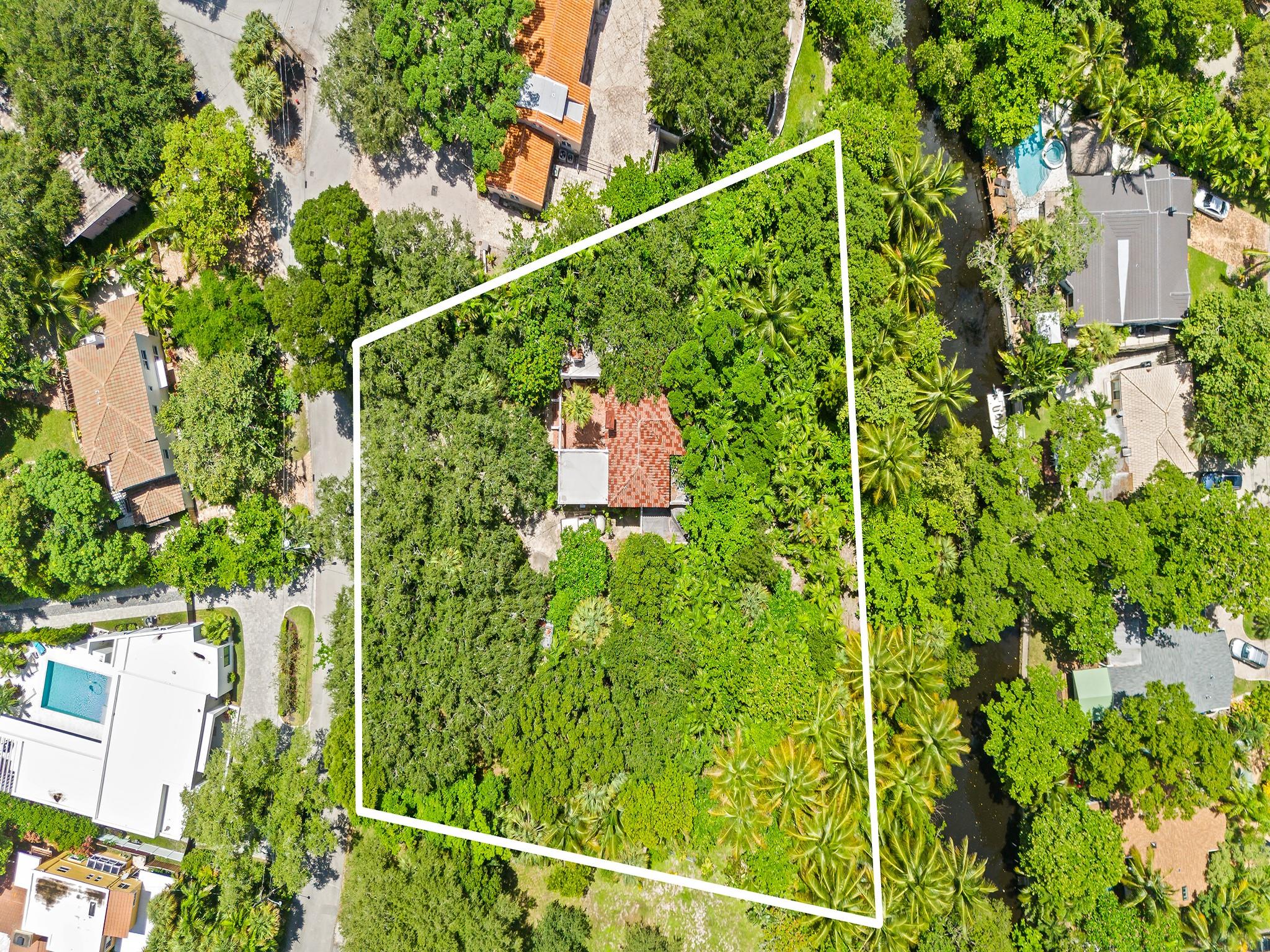 Perfectly positioned for those seeking privacy and flexibility, this one-of-a-kind property on picturesque Rose Drive presents a unique opportunity to create a custom estate, business space, or a blend of both. Tucked away behind gates on a sprawling 37,406 SF lot, this ultra-private compound boasts 207 feet of waterfront on the Tarpon River with 12' elevation in a non-flood zone. Zoned ROA | Residential Office, the property supports a wide range of residential and limited commercial uses, making it ideal for a private estate, boutique office, creative studio! The interior has been completely demod! This property can be subdivided into 2 lots. Being Sold As Is.