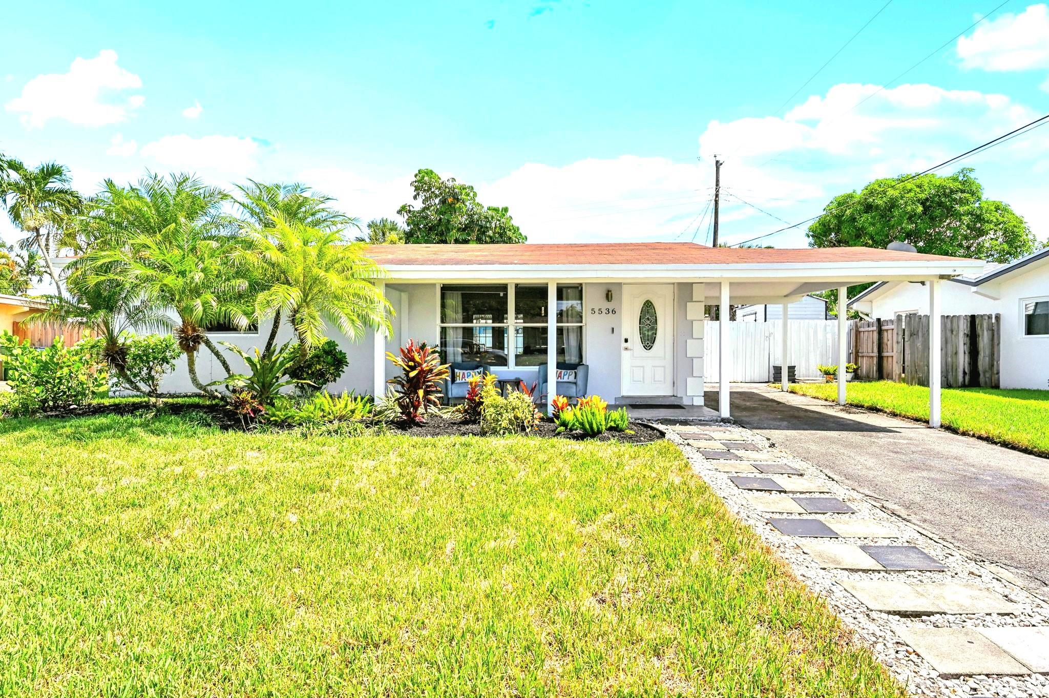 $10,000 towards Closing Costs. Welcome to Your Dream Home, just 20 mins from the sparkling shores of Pompano Beach, this charming gem shines with light, style, and upgrades. Step into a sun-filled living room with panoramic windows and elegant tiled floors. The stunning kitchen will steal your heart, dual ovens, a fabulous fridge, designer backsplash, abundant cabinets, and soft indirect lighting. The dining room overlooks a lush backyard, perfect for dinners or gatherings. The bathroom is fully updated with beautiful tilework a modern sink, and ample storage. Both bedrooms offer upgraded closets with built-ins. Has a tiled open-air patio, to enjoy your morning coffee and quiet moments. It has a shed, a covered porch, and fresh exterior paint. This is more than a home. Come fall in love!