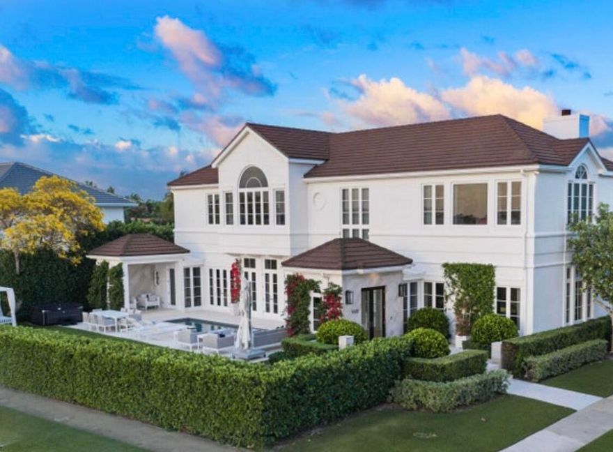 IMPRESSIVE 100-FT WATERFRONT ESTATE WITH PRIVATE DOCK, BRAND NEW 60,000 LB BOAT LIFT (ACCOMMODATES UP TO A 53-FT VESSEL & 2 OVERSIZED JET SKIS), AND 4-CAR GARAGE.  This newly renovated, 5-bedroom designer-furnished residence offers spectacular Billion-dollar views of the Estate section of Palm Beach Island and the widest section of the Intracoastal. 11-ft ceilings and 6,000 square feet of refined living space. Highlights include a showpiece waterfront bar and lounge, expansive primary suite with dual dressing rooms, attractive open kitchen with Wolf and Sub-Zero appliances, elevator, guest house, and resort-style amenities throughout. FURNISHINGS INCLUDED. The very impressive waterfront bar/lounge features LED backlit crystalline quartzite a stunning brass sink, ice maker, and custom  cabinetry. A sprawling primary suite complete with oversized dual dressing rooms with Italkraft closets and custom cabinetry. This home has an abundance of natural light, high-end finishes, and every conceivable amenity for those who love to entertain. The open kitchen features premium Wolf and Subzero appliances. More recent upgrades include a wine refrigerator in the dining room, custom lighting to enhance artwork, and an above ground spa. This sophisticated 2-story home also includes a guest apartment for extended stays or ultimate privacy. Overhauled under the guidance of designer Amir Khamneipur, known for his work at The Bristol, every element of this home is crafted for luxury living wine wall inspired by the Breakers Resort, putting green, gated driveway, full house generator, integrated smart home system, and elevator. Ideally located near Palm Beach Island with views of Mar-a-Lago and close to premier dining, shopping, and PBI Airport. This is a rare opportunity to own one of SoSo's finest properties!