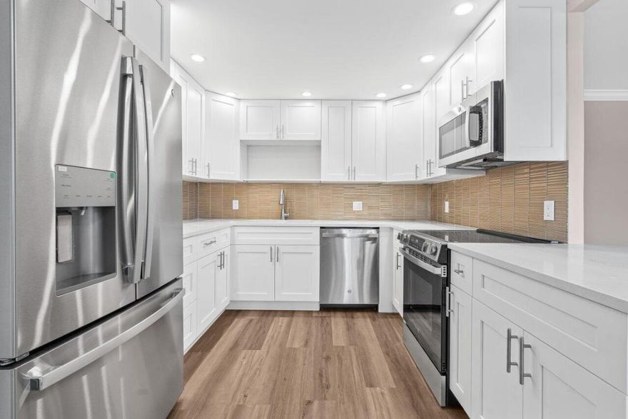 Beautiful updates in this pristine two bedroom and full two bath unit. Located in the BEST luxury building of Century Village East. New Roof. No assessments. All inspections completed. Reserves met. New impact windows and doors throughout. Open kitchen concept with white shaker cabinets, brand-new, stainless-steel GE appliances, quartz countertops, and glass tile backsplash. Top of the line wood-look laminate flooring. Freshly painted with elegant and neutral high-end paint. No Popcorn on ceilings. Primary room has large walk-in closet with custom built-ins and fully updated ensuite bathroom with glass shower doors. Guest bathroom is also fully updated. Spacious second bedroom with both rooms leading out to your private enclosed Patio overlooking the protected nature preserve. South facing patio has ample Florida sunshine and beautiful views of the serene nature preserve. Complete with newer A/C & brand new water heater. Oakridge D is extremely well-maintained building. Century Village has a newly redesigned clubhouse that offers over three-acres of entertainment, fitness, arts, resort style pool and indoor pool. Located just 3.5 miles from the Beach. Close to 95, turnpike, sawgrass, shopping and restaurants.