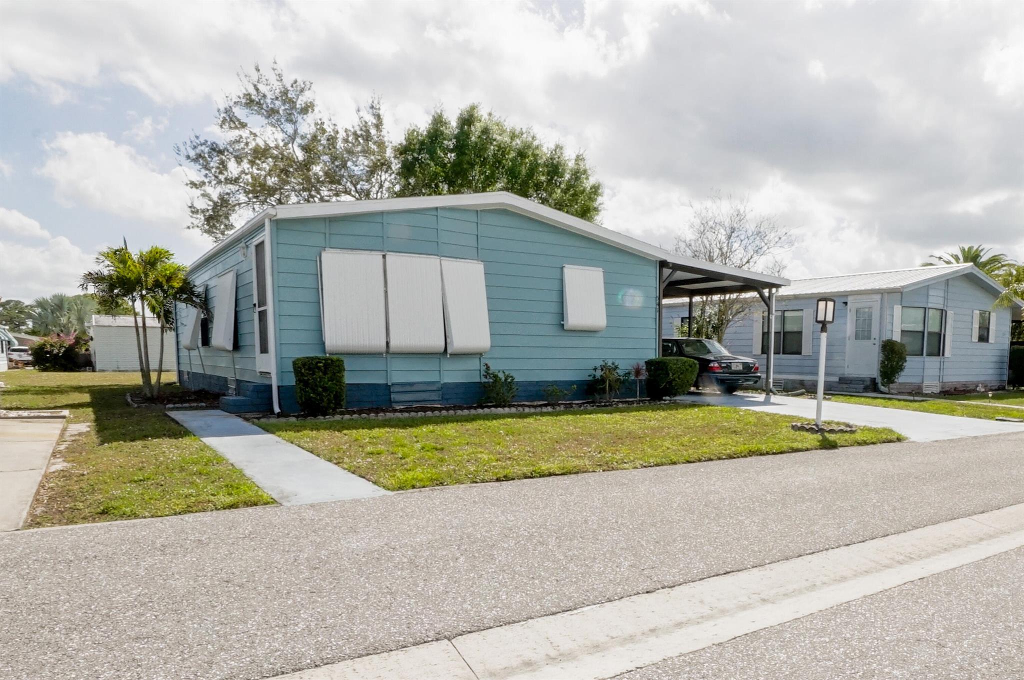 This 2 Bed/2 Bath, 1014 Sq Ft home, features a large kitchen with solid wood cabinets, kitchen island, and an open floor plan with living room and dining areas. as well as nicely sized bedrooms and walk in closets, a separate laundry room,which leads to a screened in lanai and large storage closet. The low HOA fee of $197 per month includes: basic cable, internet, trash removal and a whole host of amenities like the clubhouse, heated pool, shuffleboard, and more..there is even RV/Boat Storage. The home is being sold furnished and is ready for you to move right in. La Buona Vita, is a 55+ Coop Community with NO Land Lease fees?